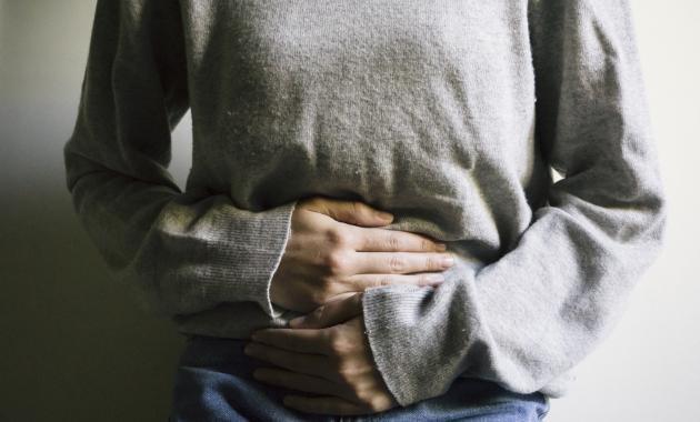 A person experiences stomach pain due to exocrine pancreatic insufficiency (EPI)