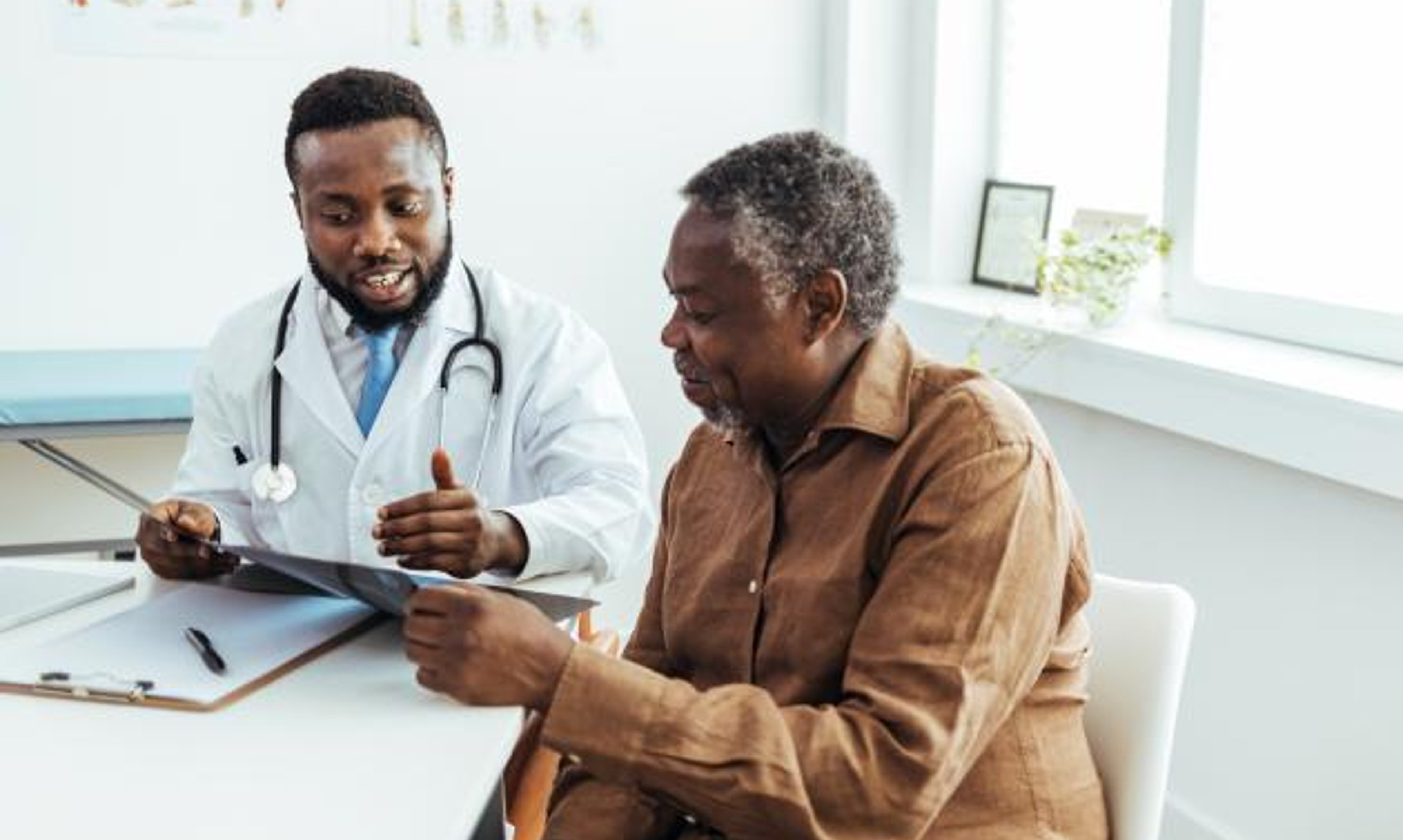 Black healthcare professional speaking to mature Black woman