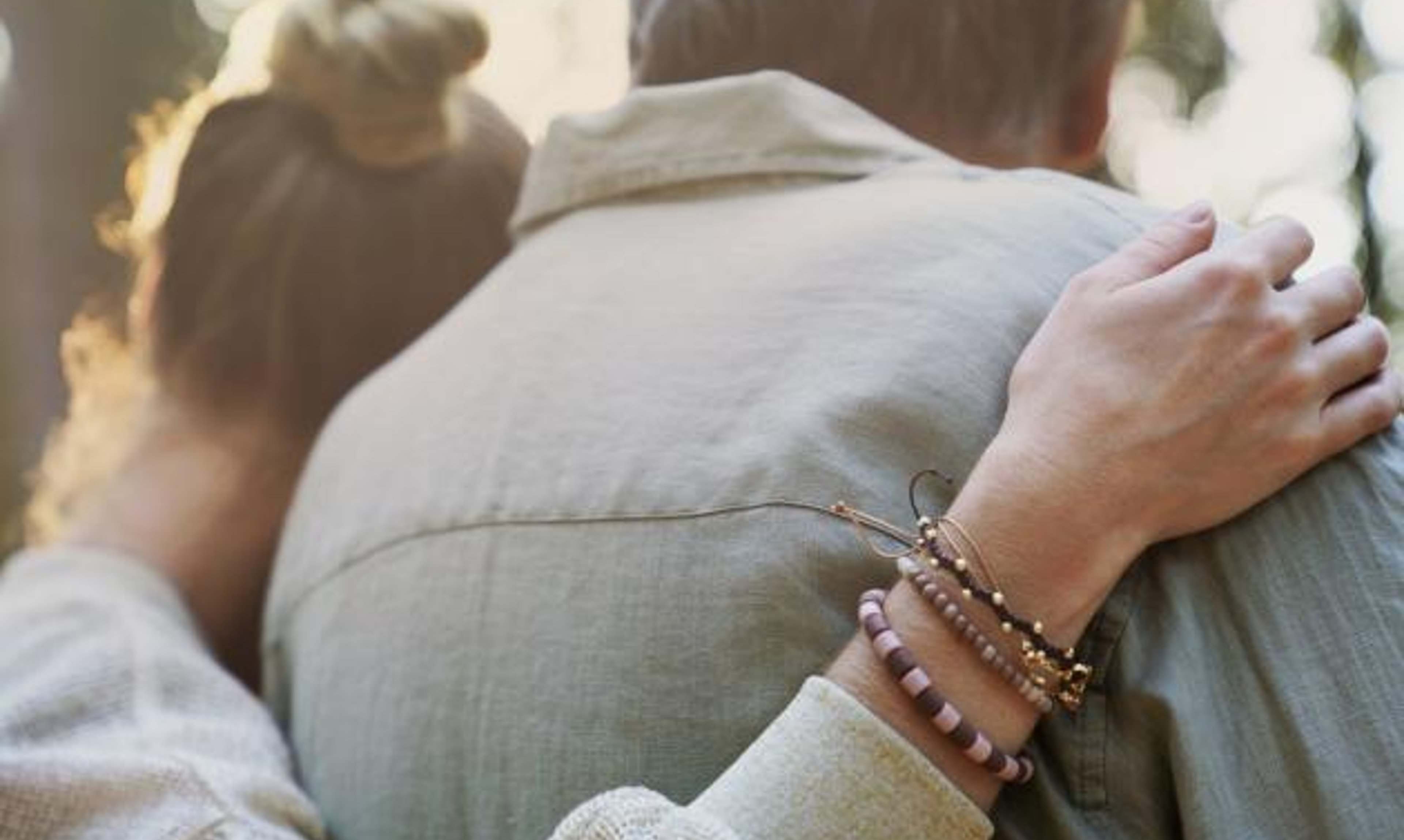 A younger woman and older man embrace. 