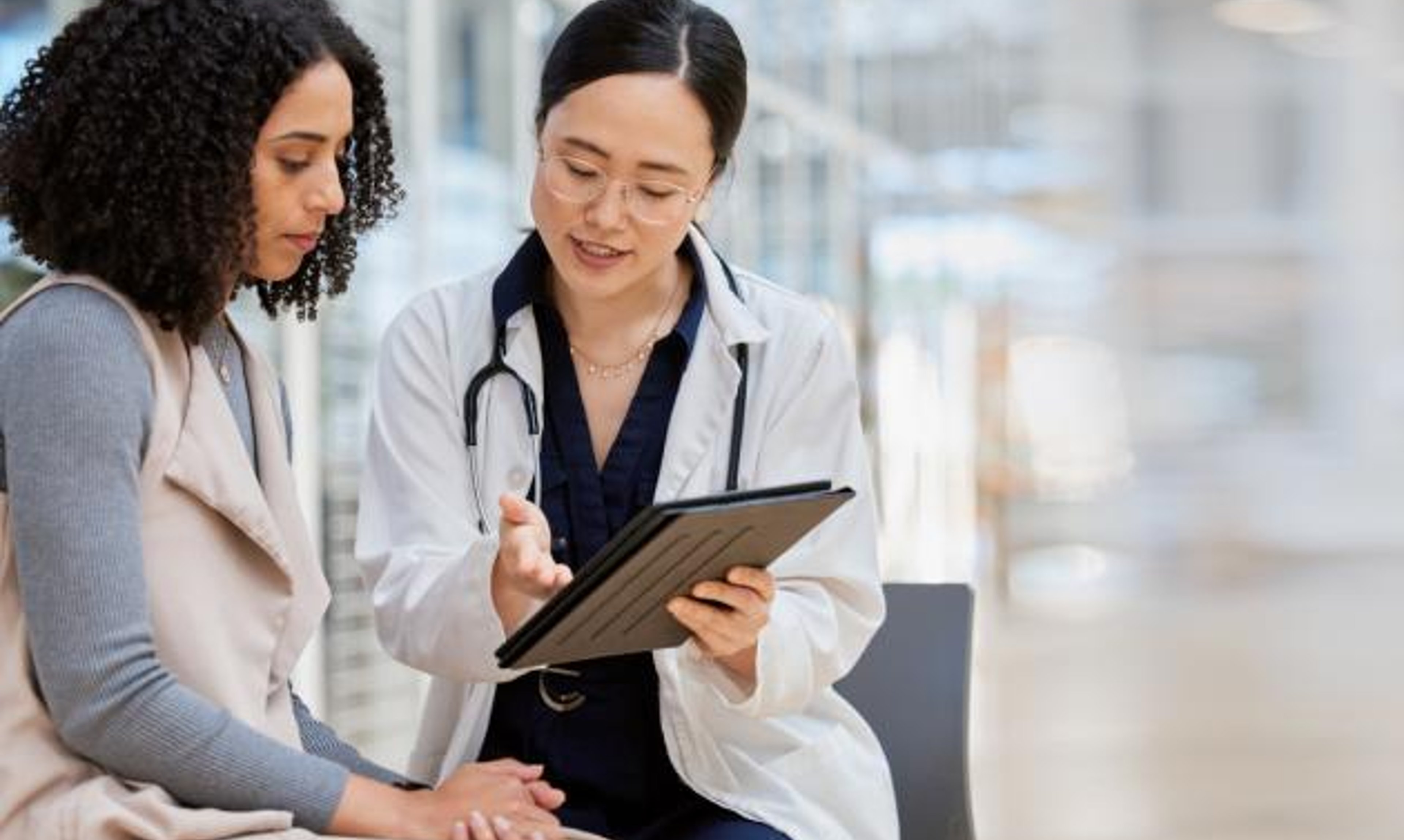 A doctor consults with a person in a lab.
