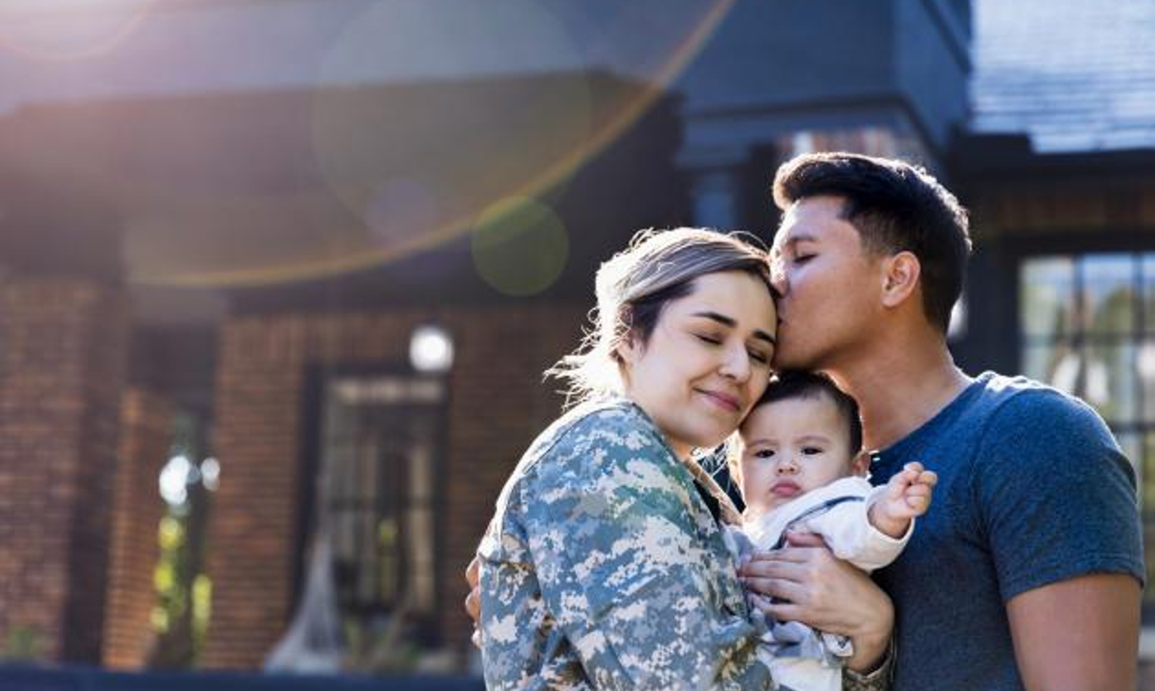 U.S. Veteran family with baby in group hug