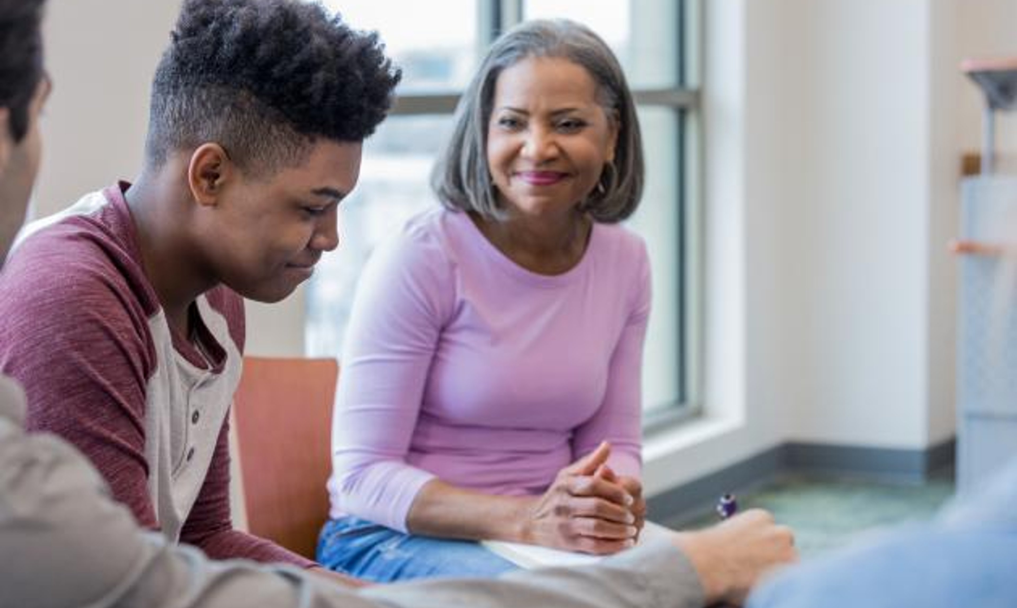 Woman talking to young man