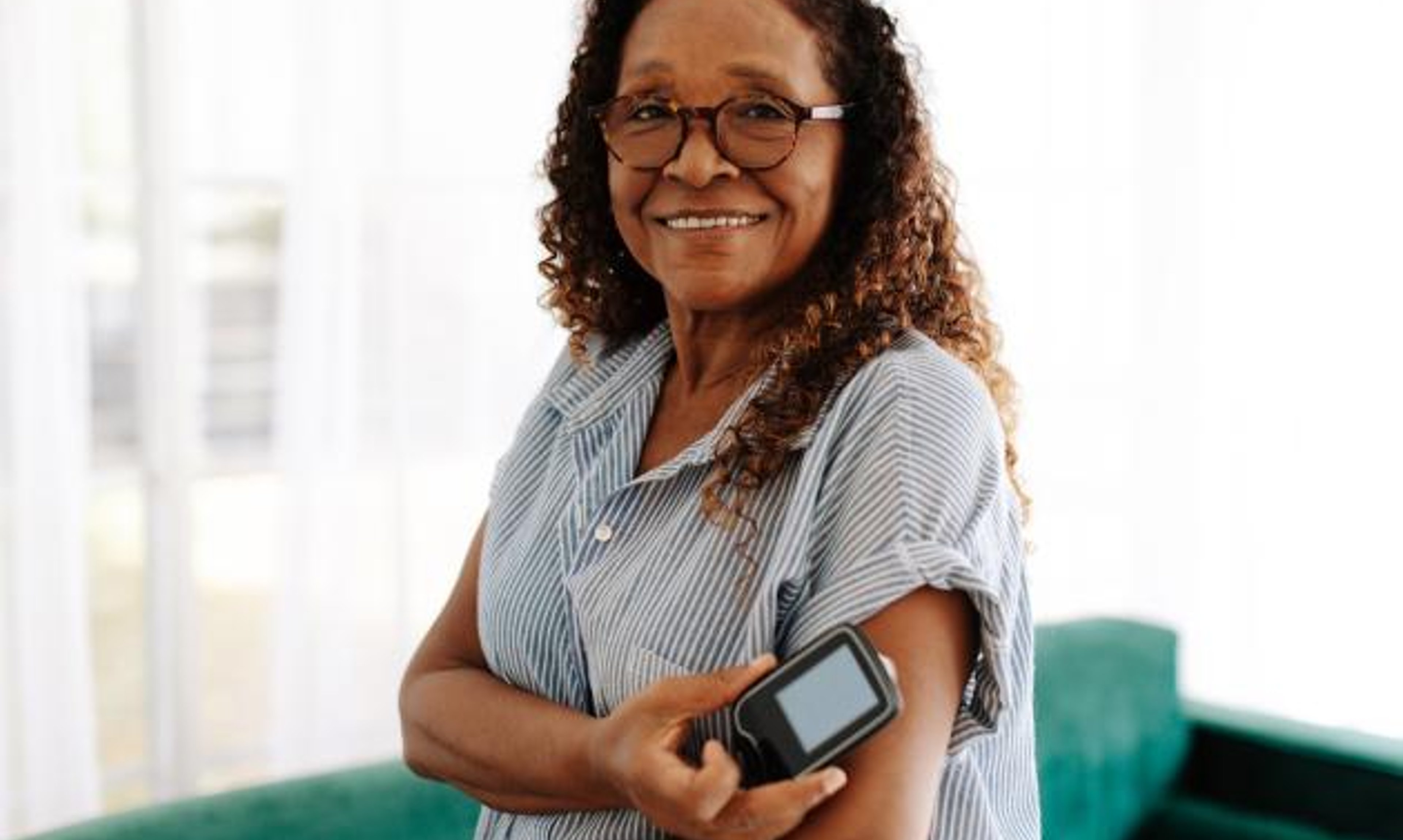 woman checking her blood sugar with CGM