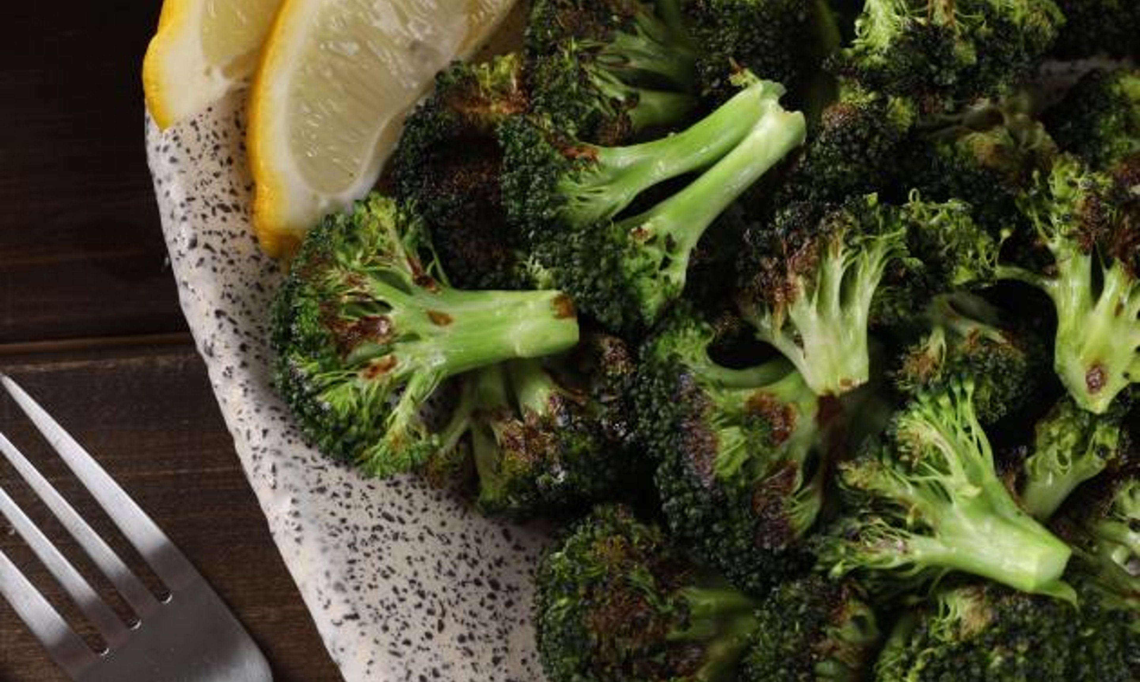 Roasted Broccoli with Lemon Wedge in Bowl