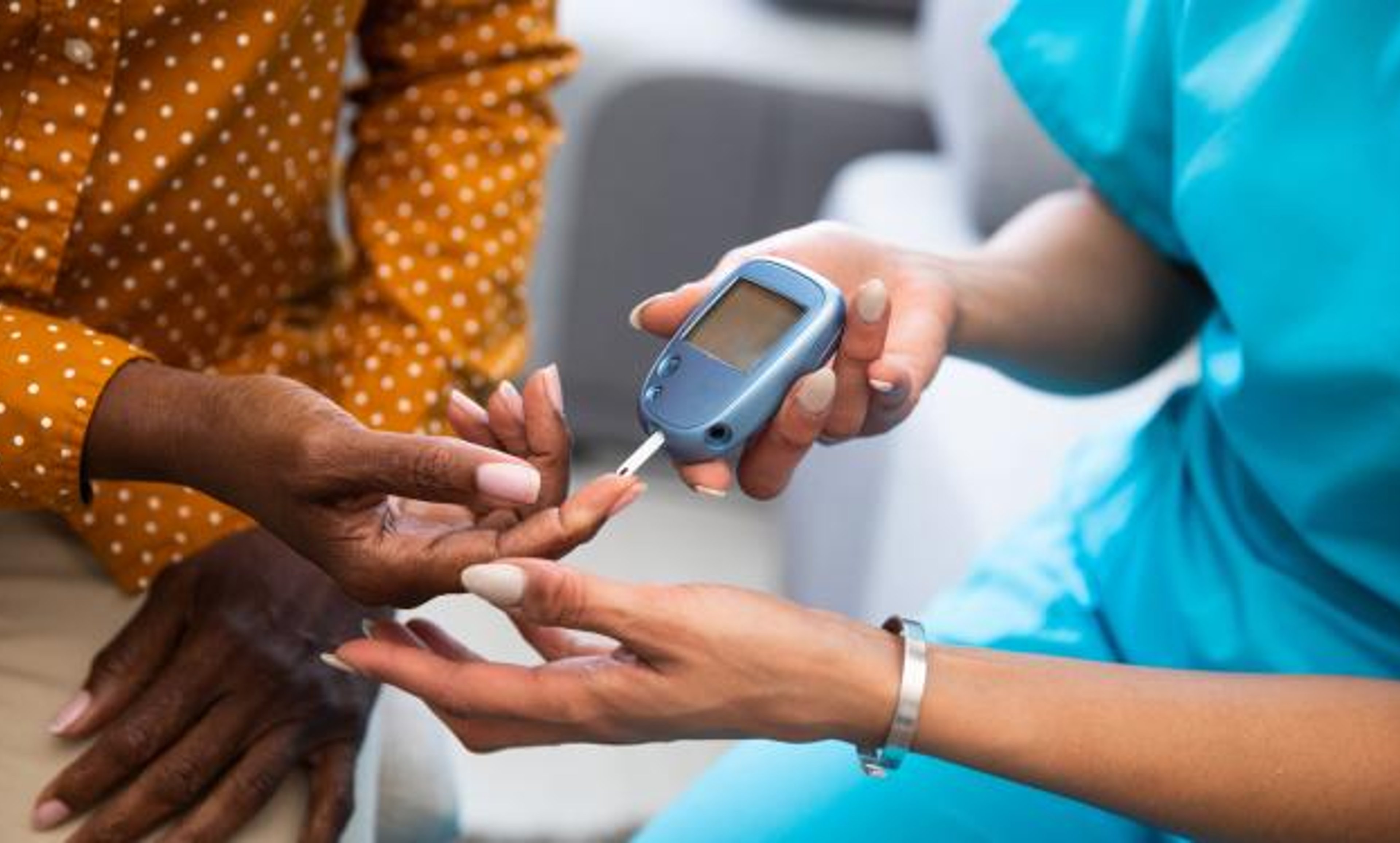 Medical professional taking a person's blood glucose reading