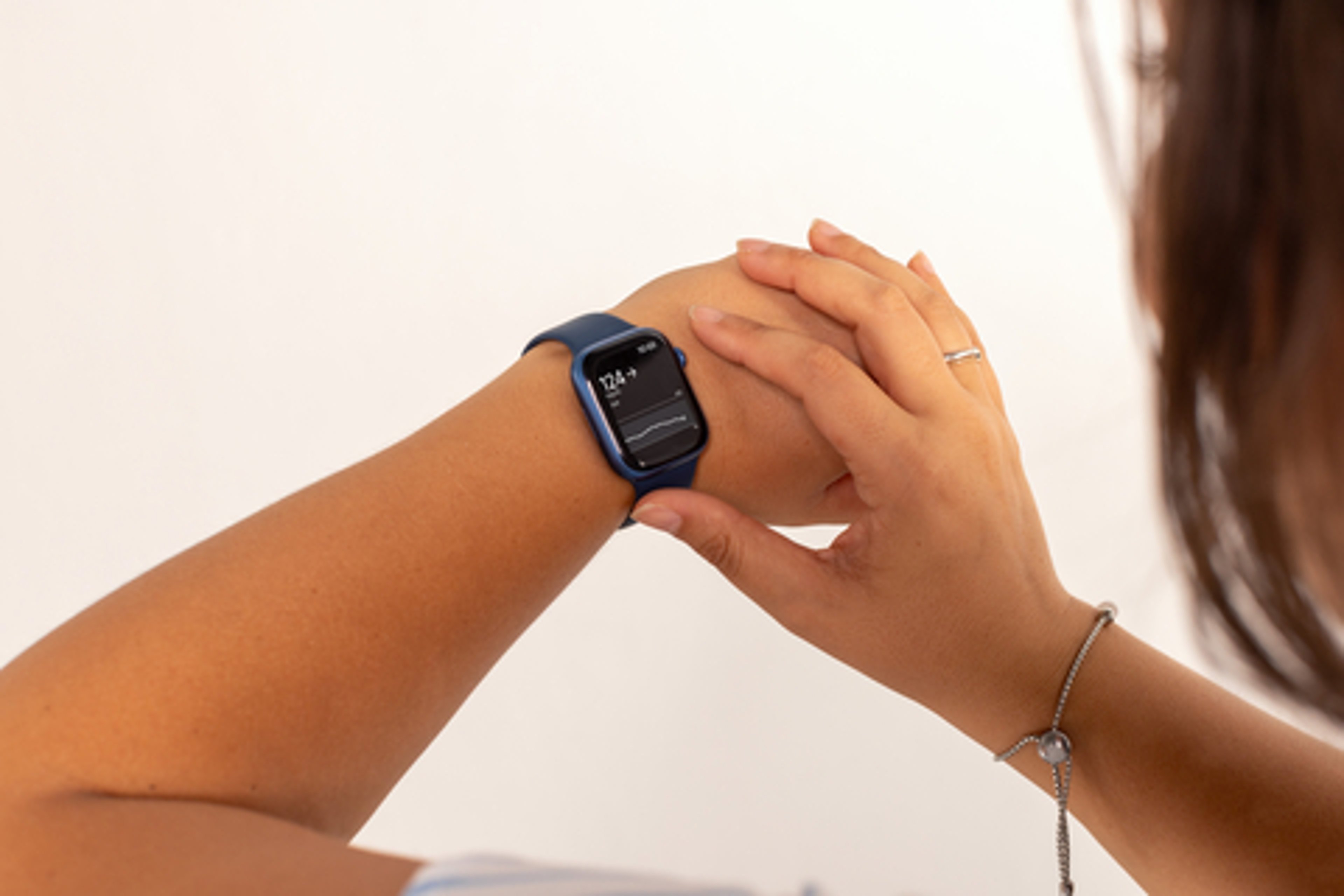 Closeup of woman checking glucose on watch using Dexcom Direct-to-Apple Watch feature