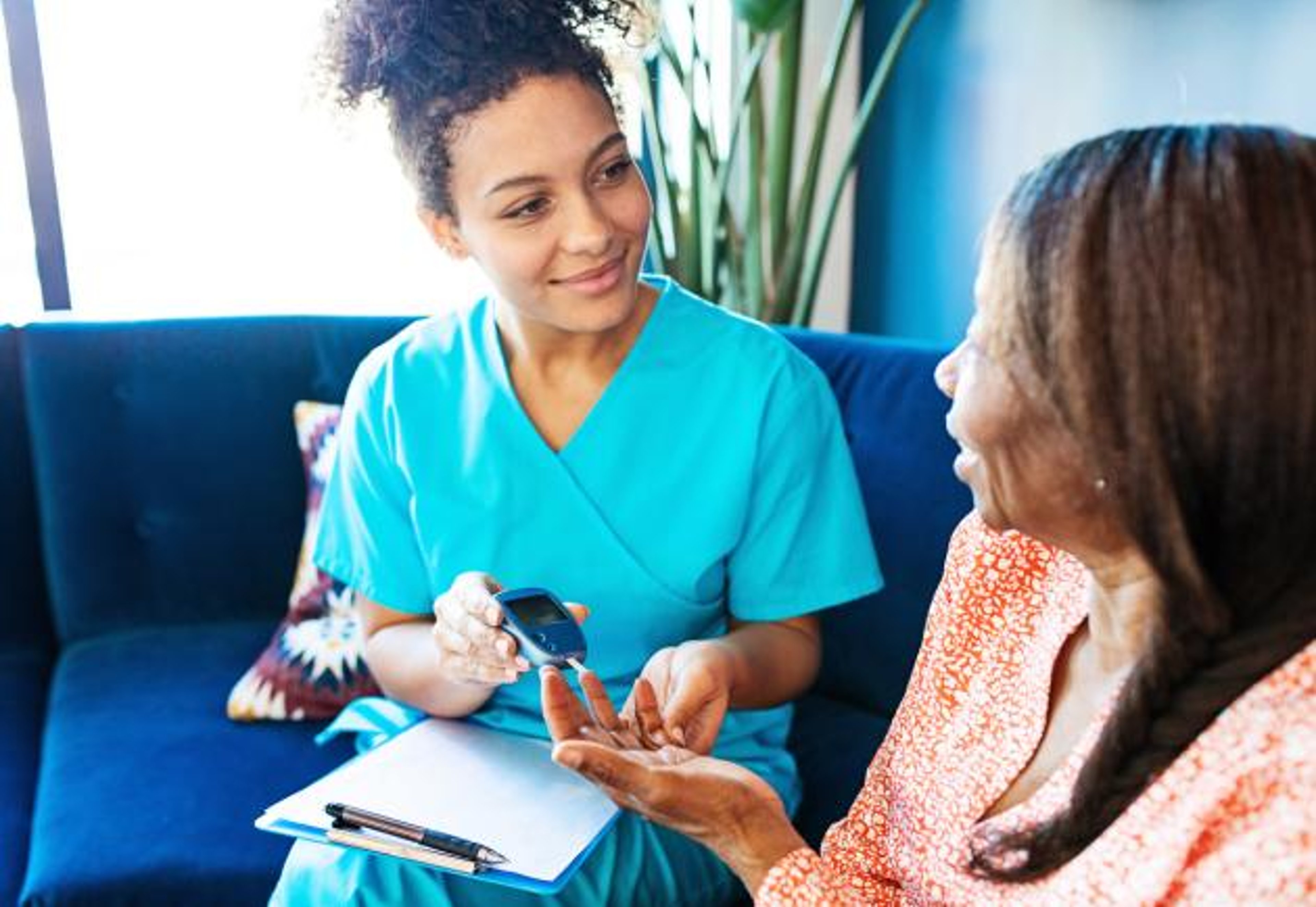 Nurse conducting blood glucose test on patient