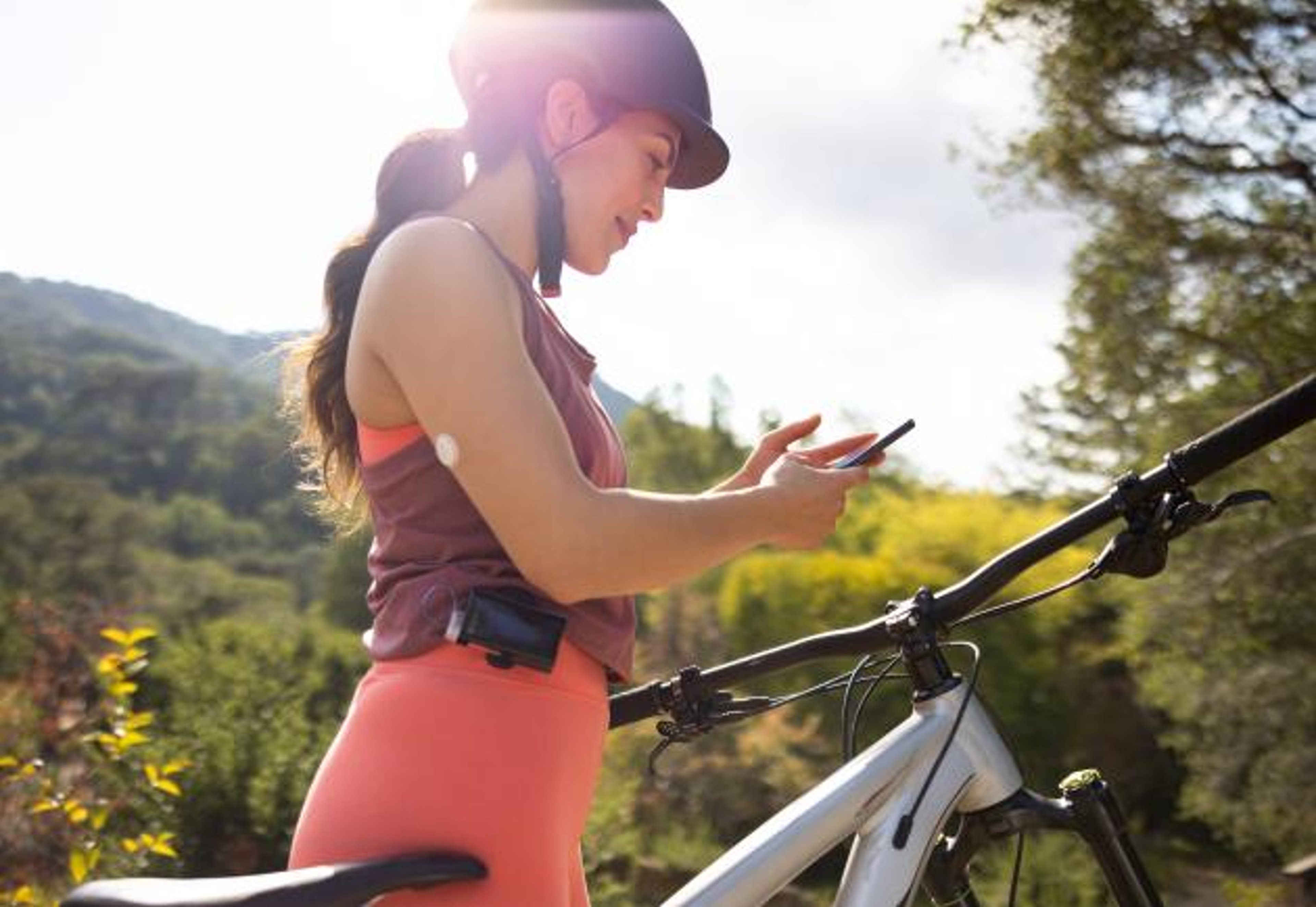 Woman working out and wearing Abbott Freestyle Libre 3 on arm