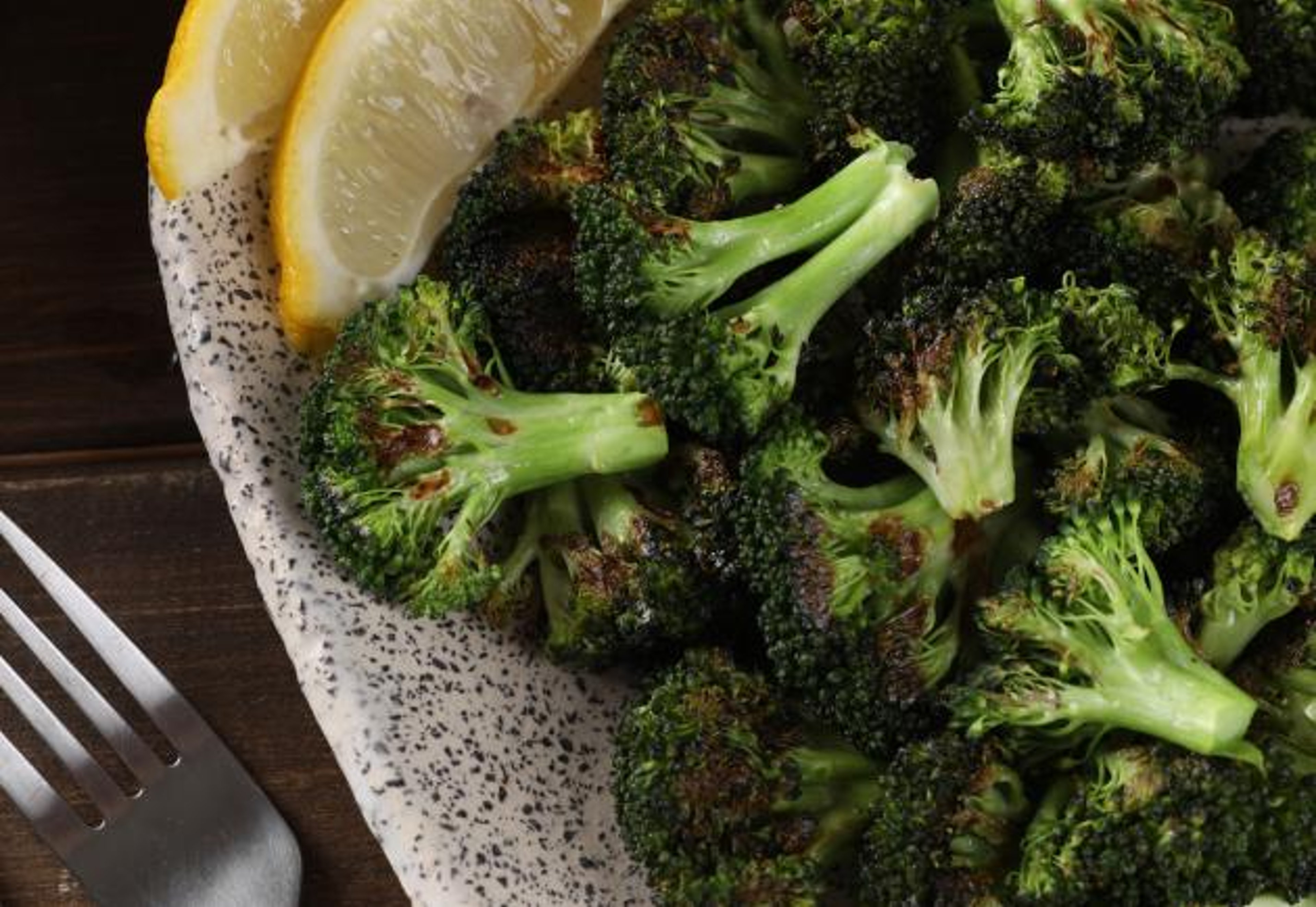 Roasted Broccoli with Lemon Wedge in Bowl