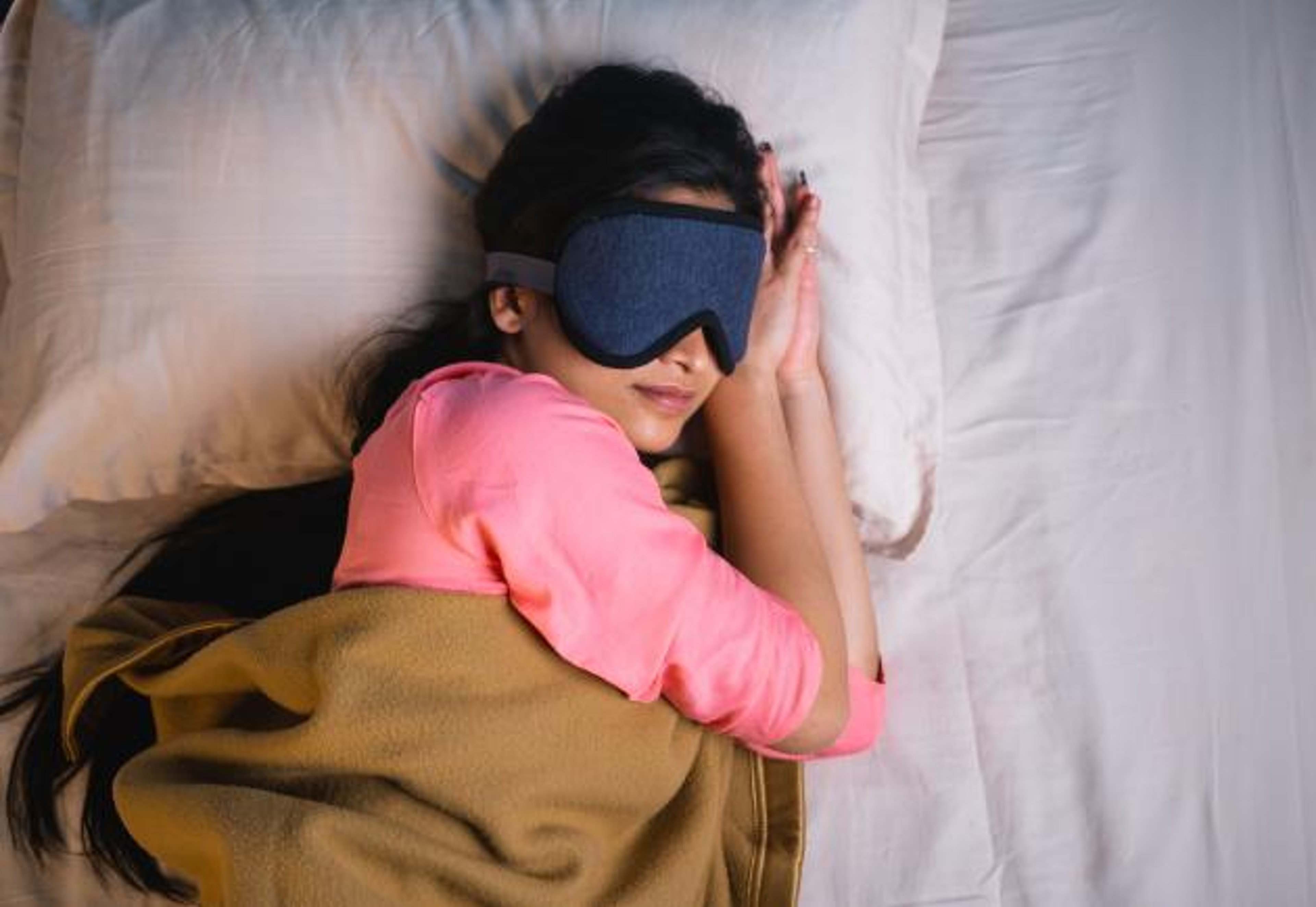 South Asian woman sleeping with eye mask