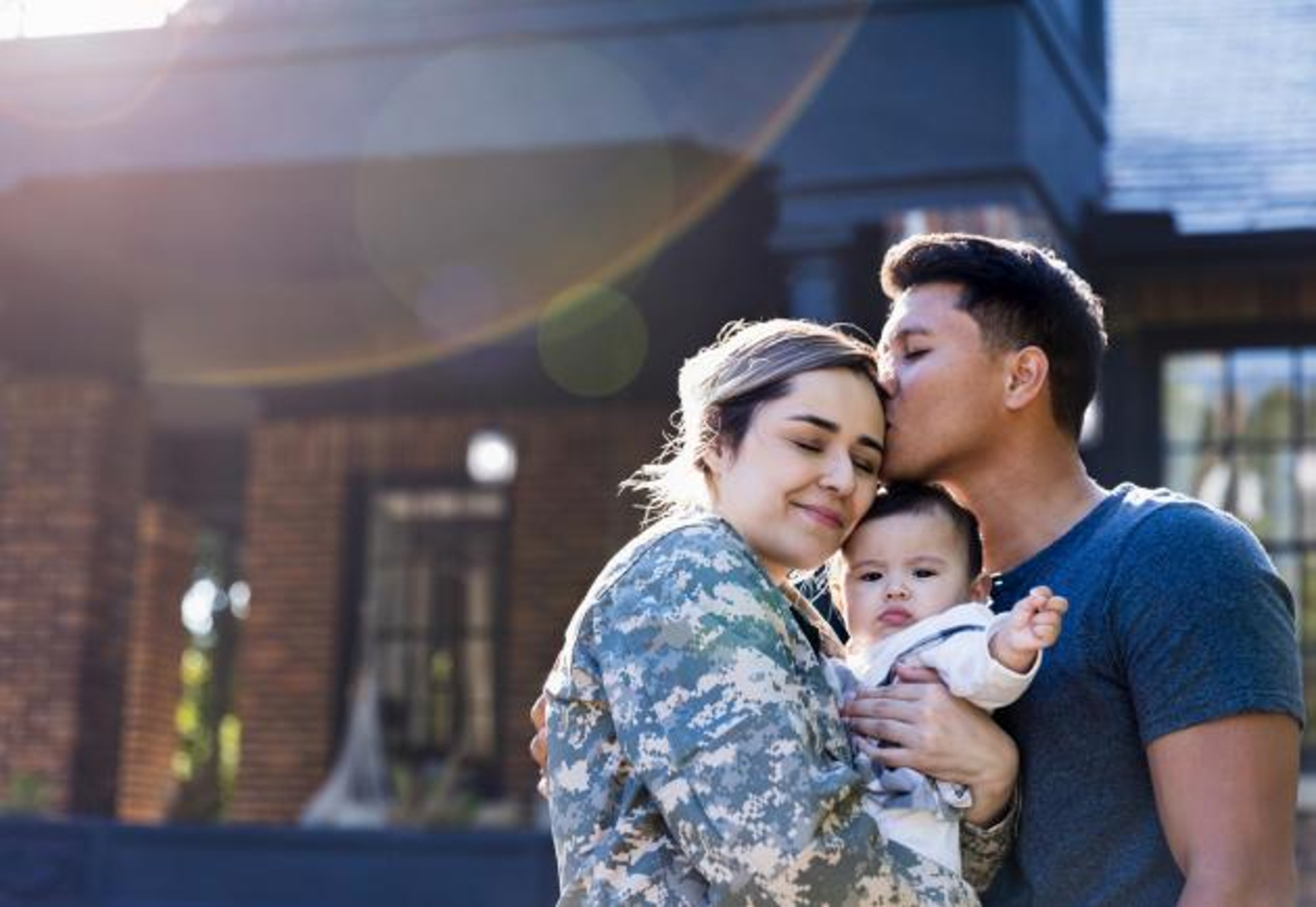 U.S. Veteran family with baby in group hug