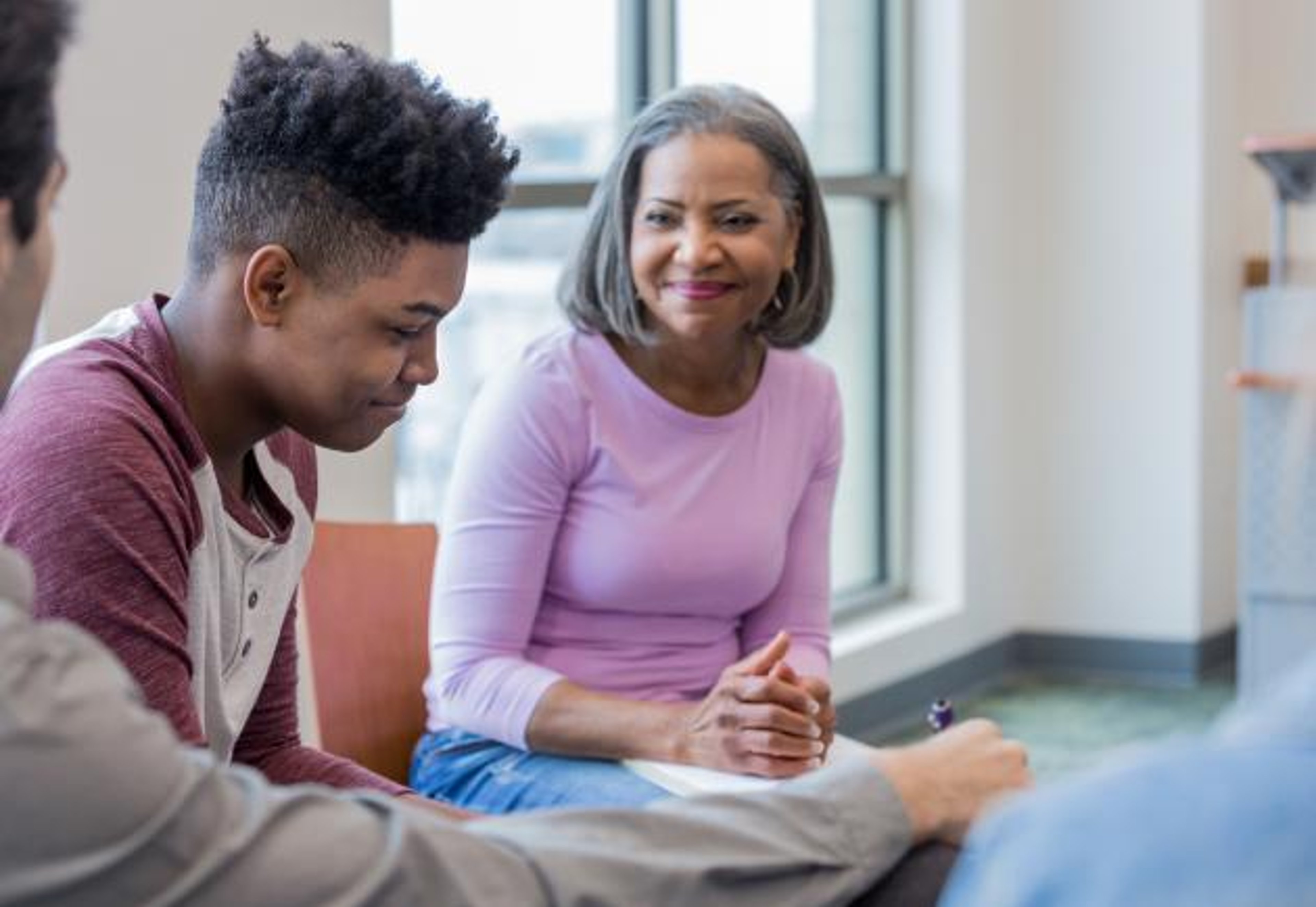 Woman talking to young man