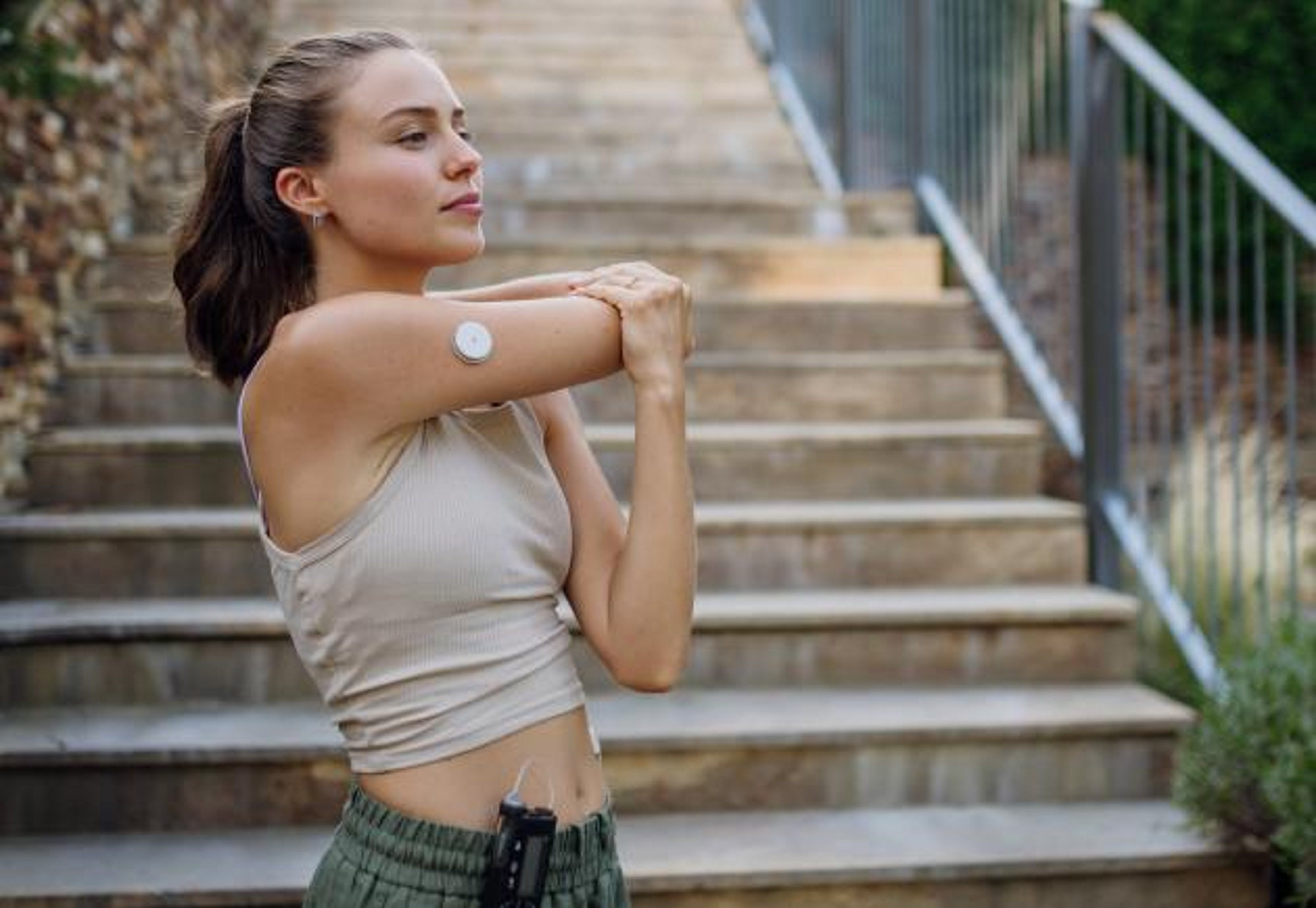 Woman wearing CGM stretching