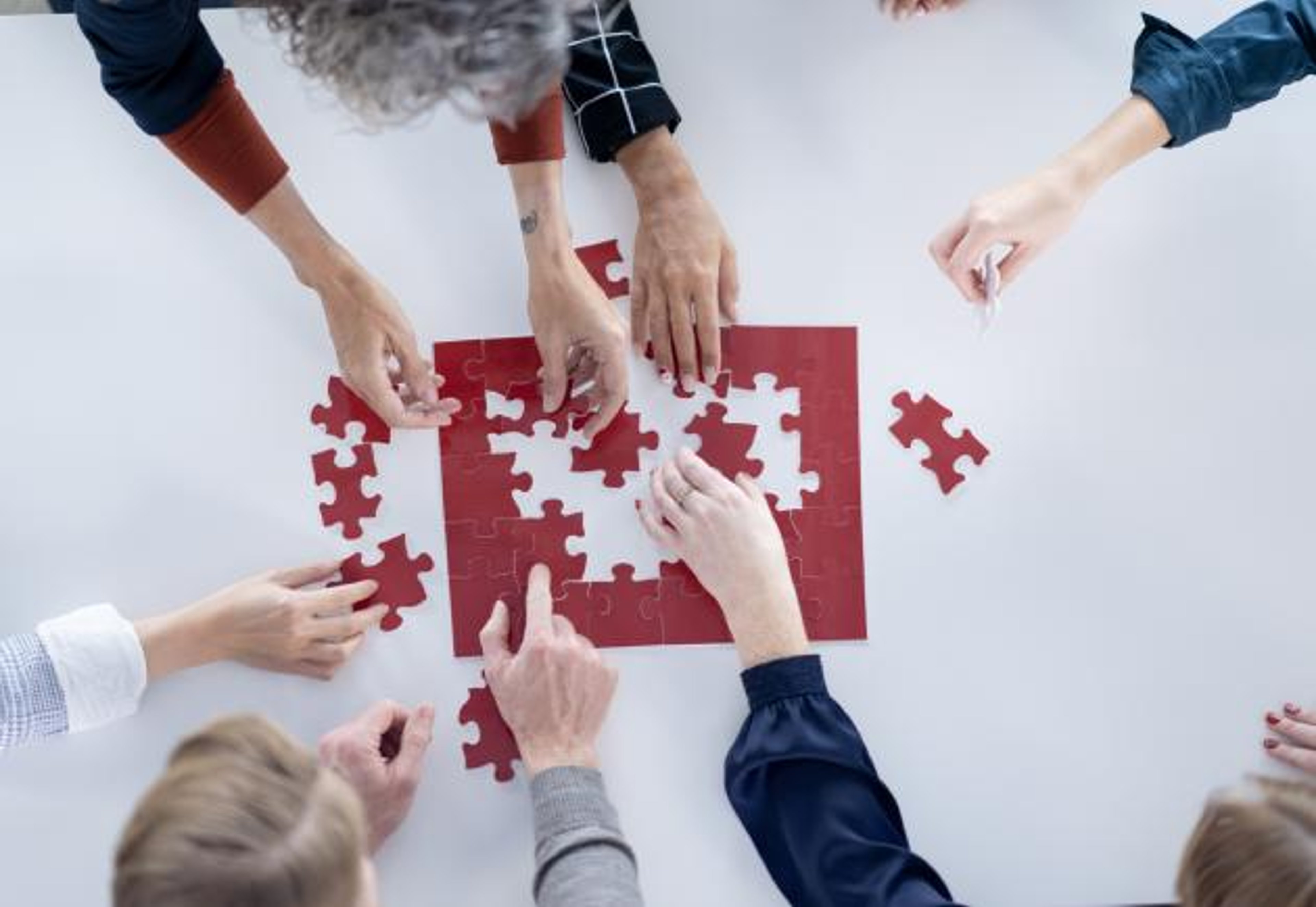 hands solving a puzzle