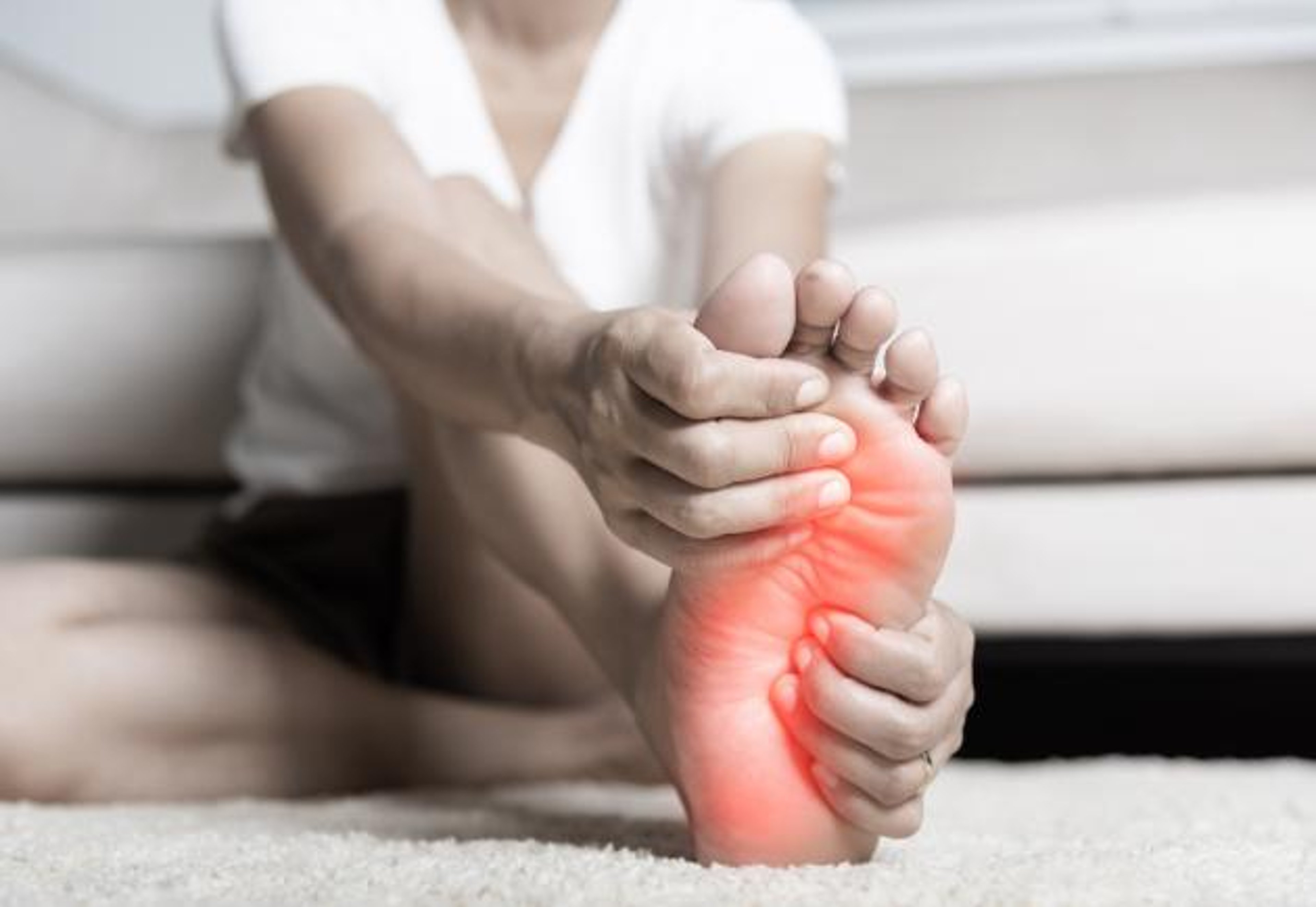 woman feeling pain in her foot