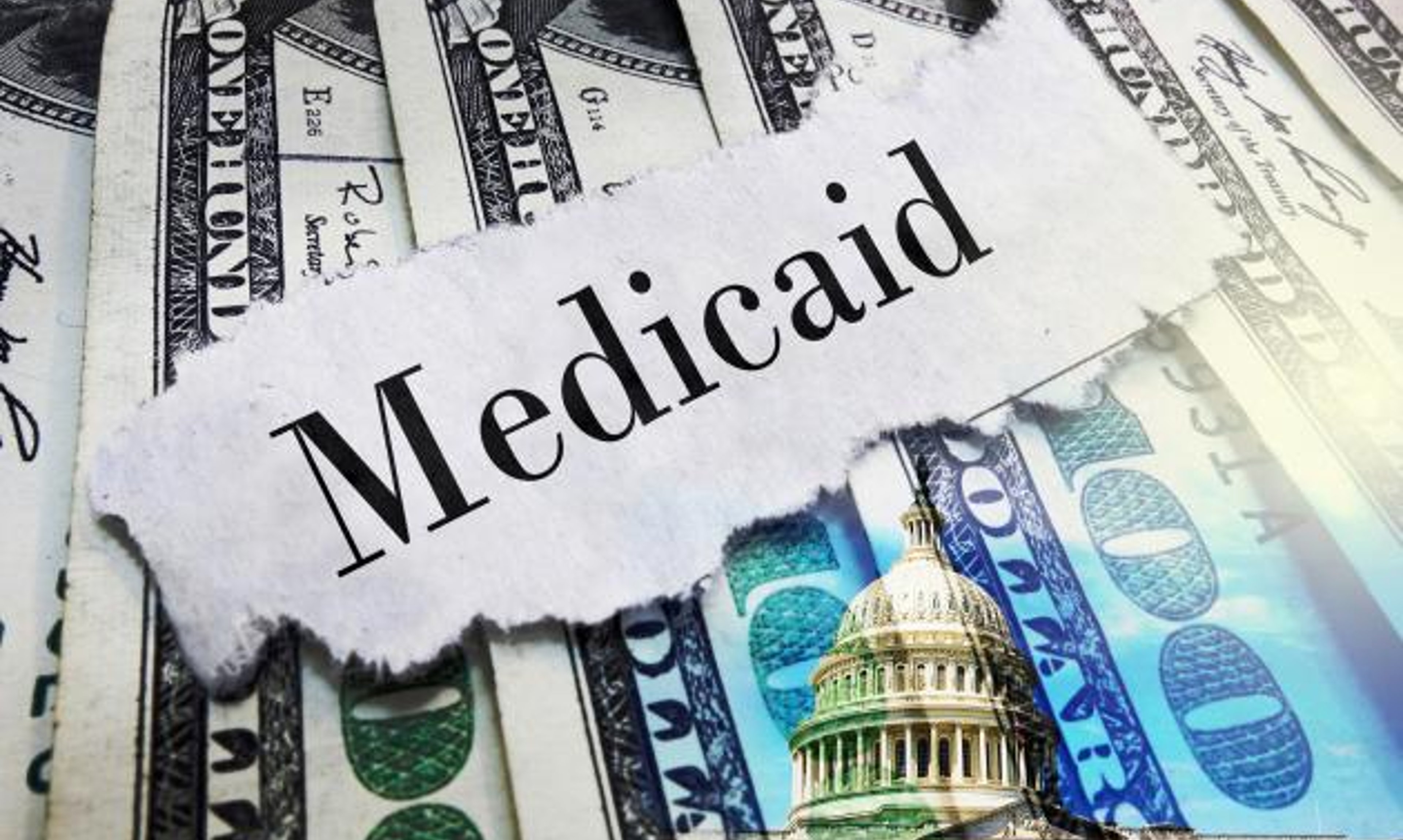 Medicaid newspaper headline on hundred dollar bills with US Capitol in Washington DC