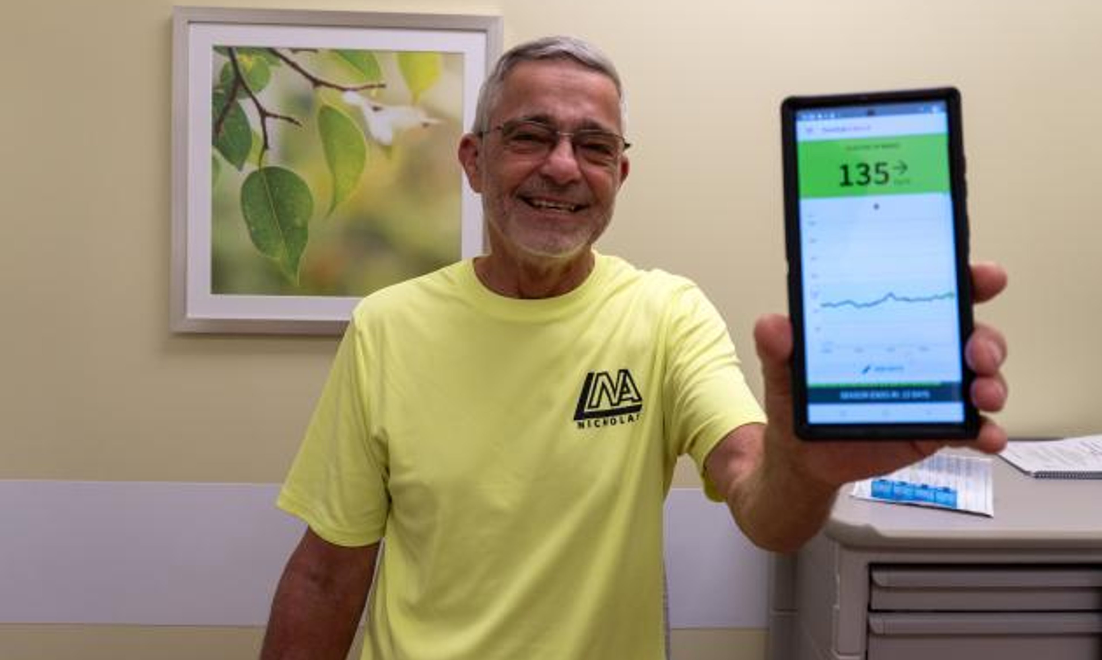 Ed Augustin, the first recipient of an FDA-approved islet cell treatment called Lantidra, showing his blood sugar reading shortly after the procedure.