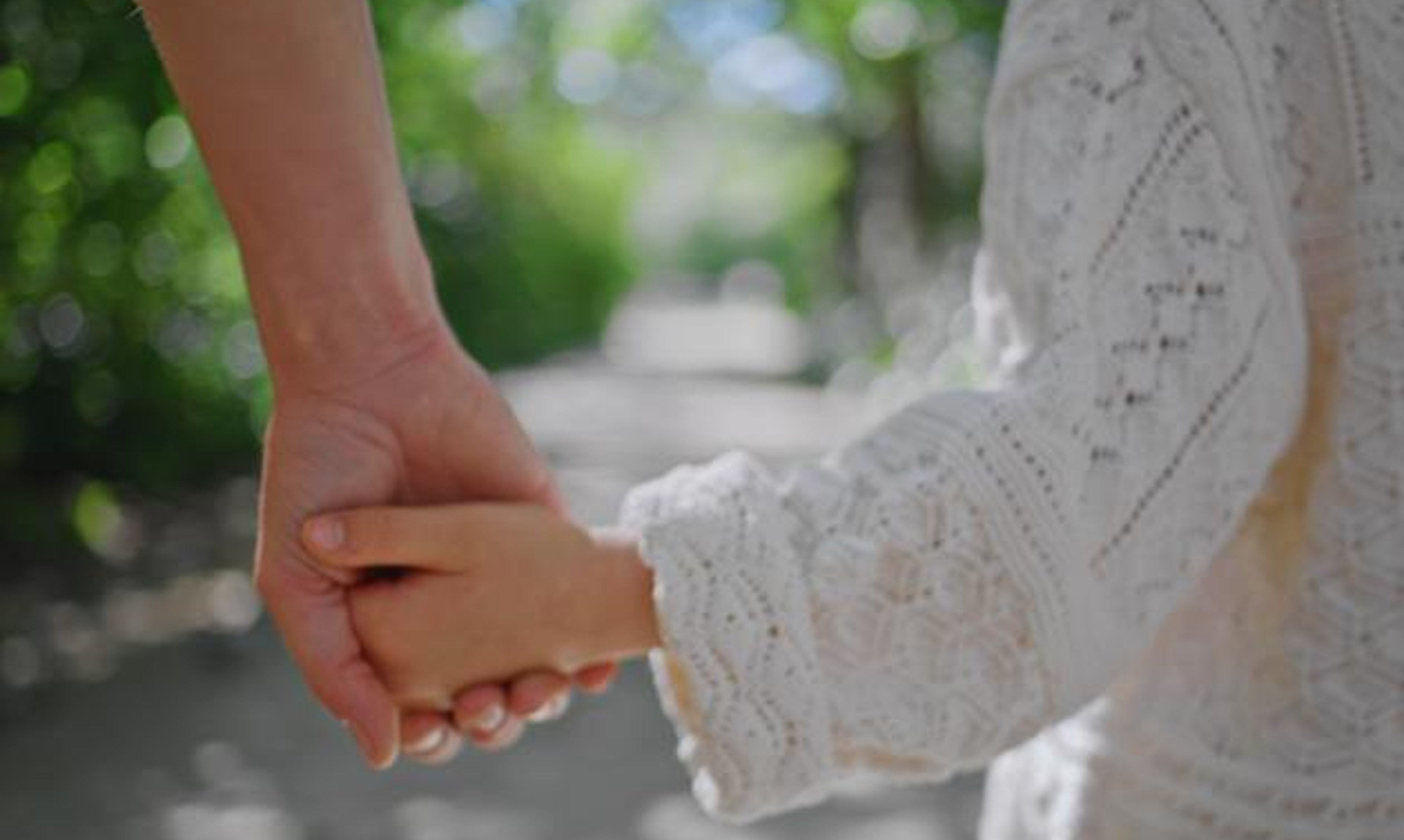 Mom holding hands with child