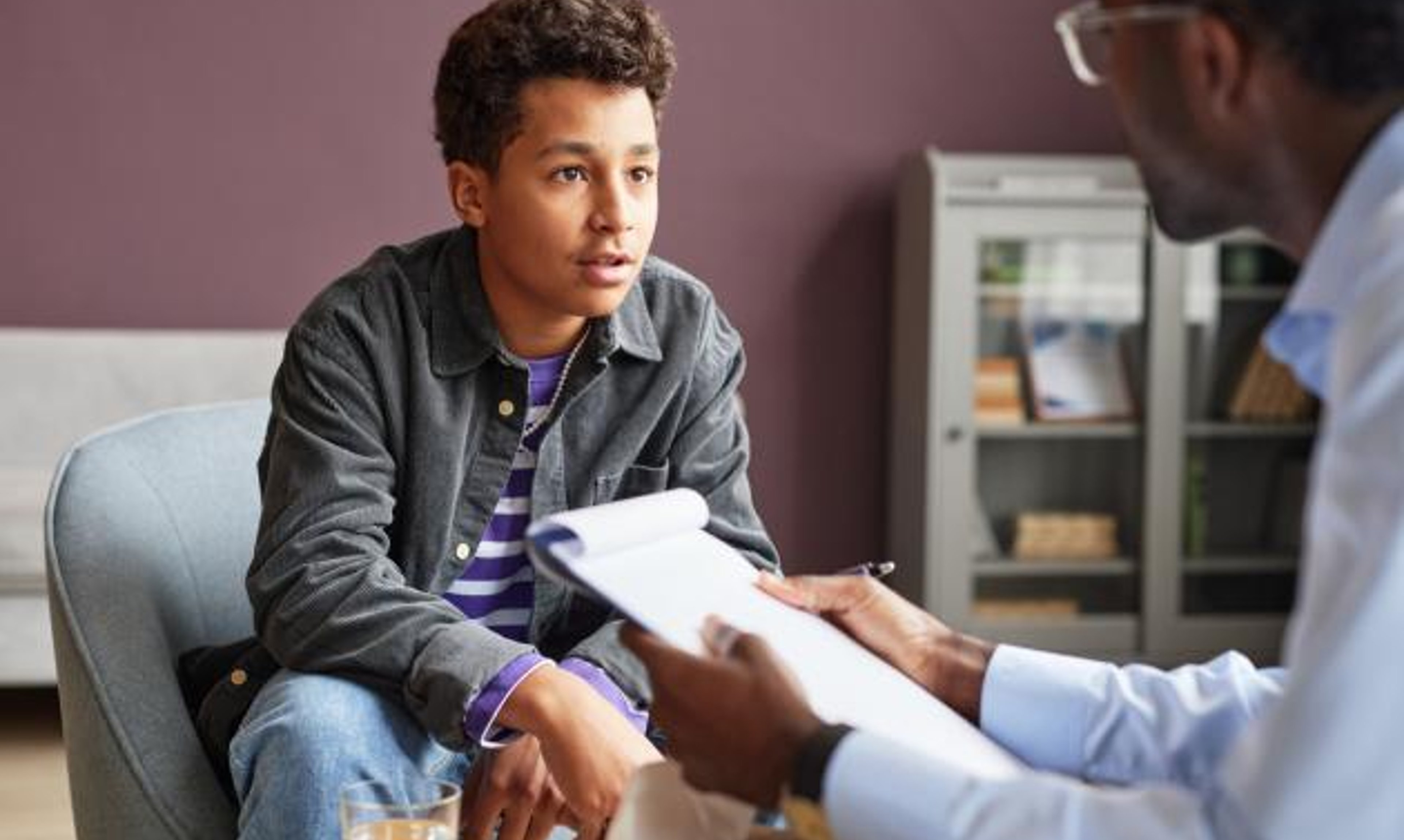 Young man talking to doctor