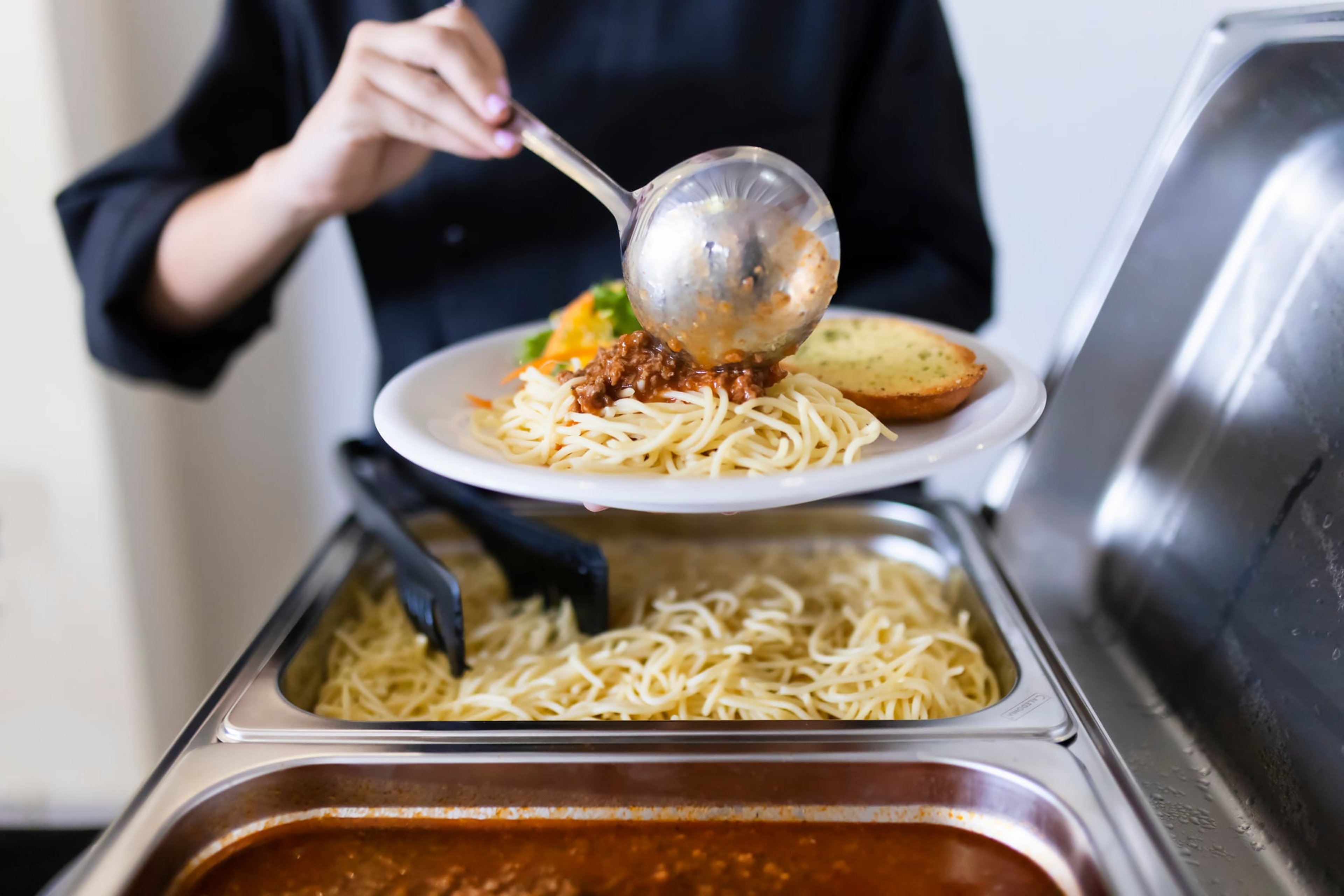 Cook serving food on a plate stock photo