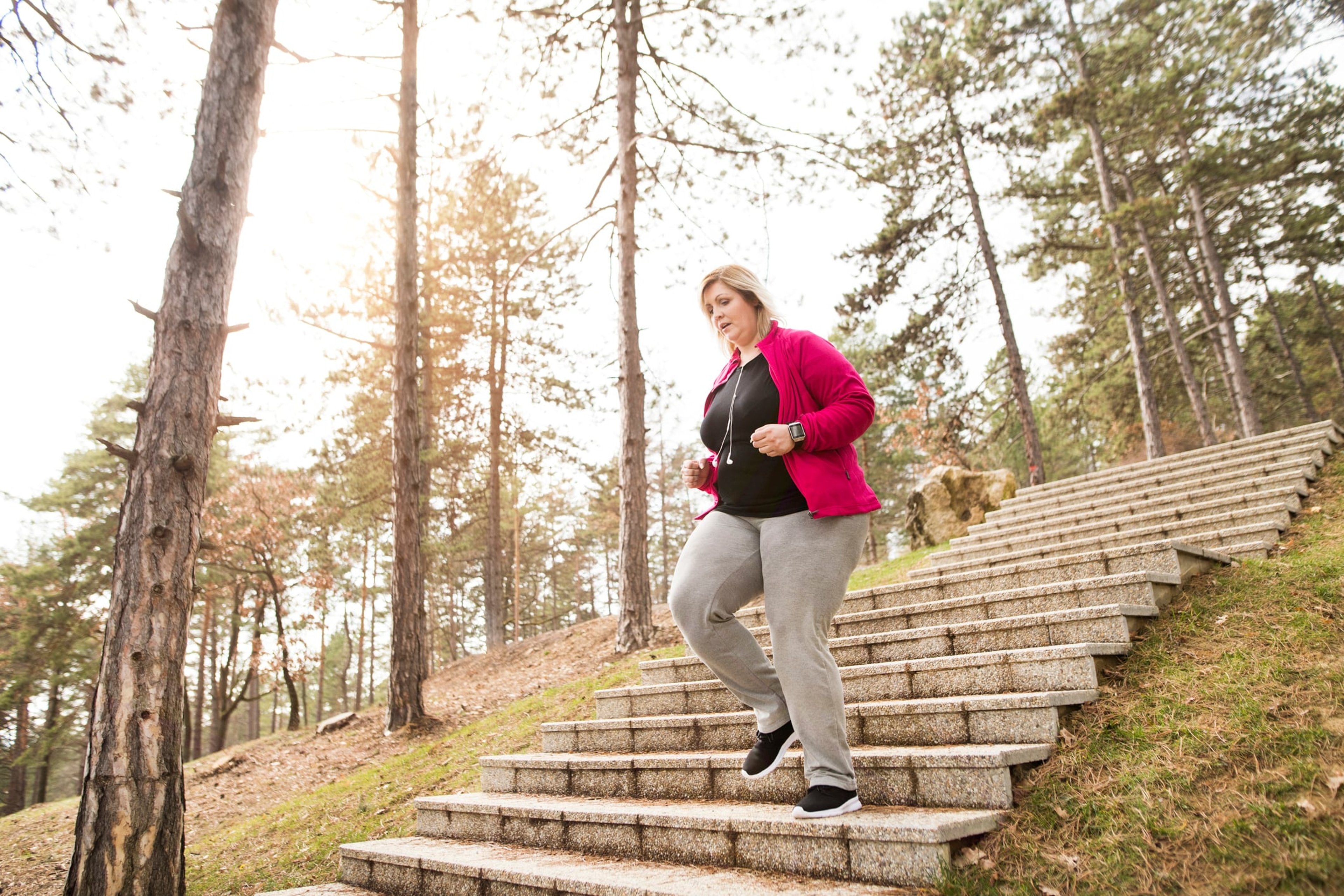 woman jogging down stairs outside