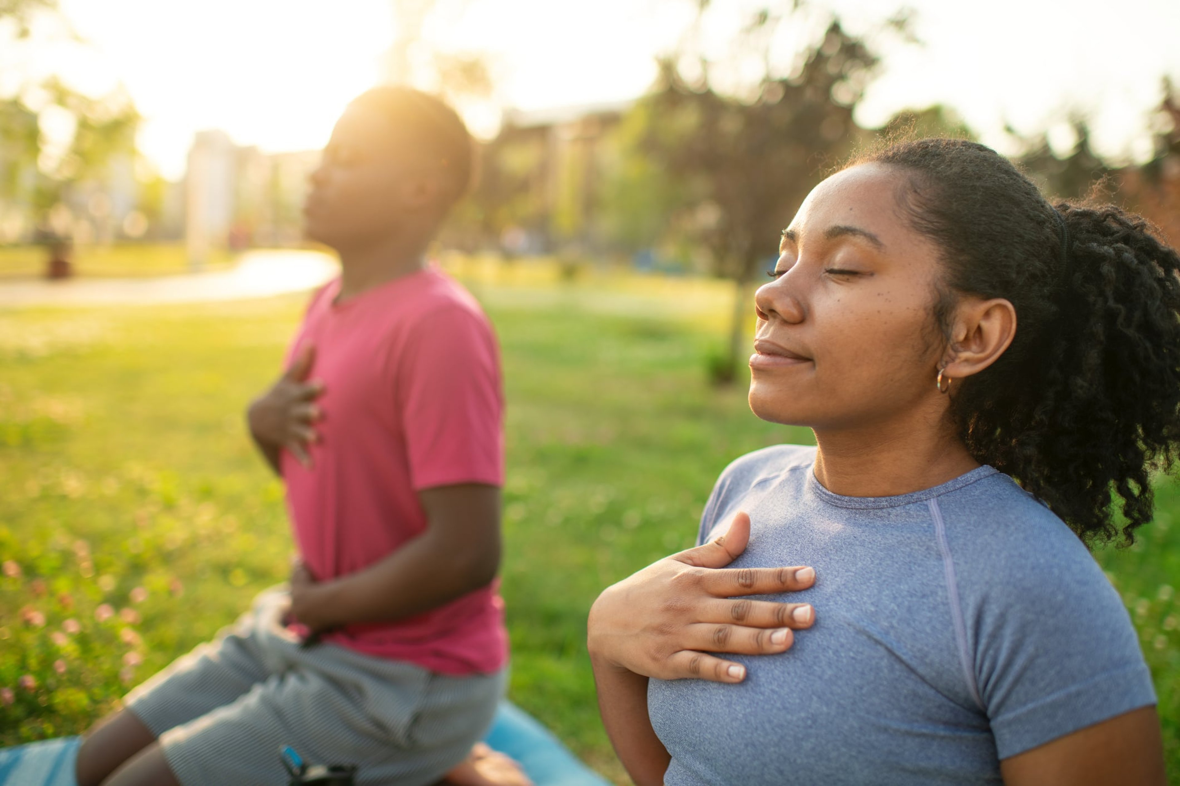 couple practicing yoga at park