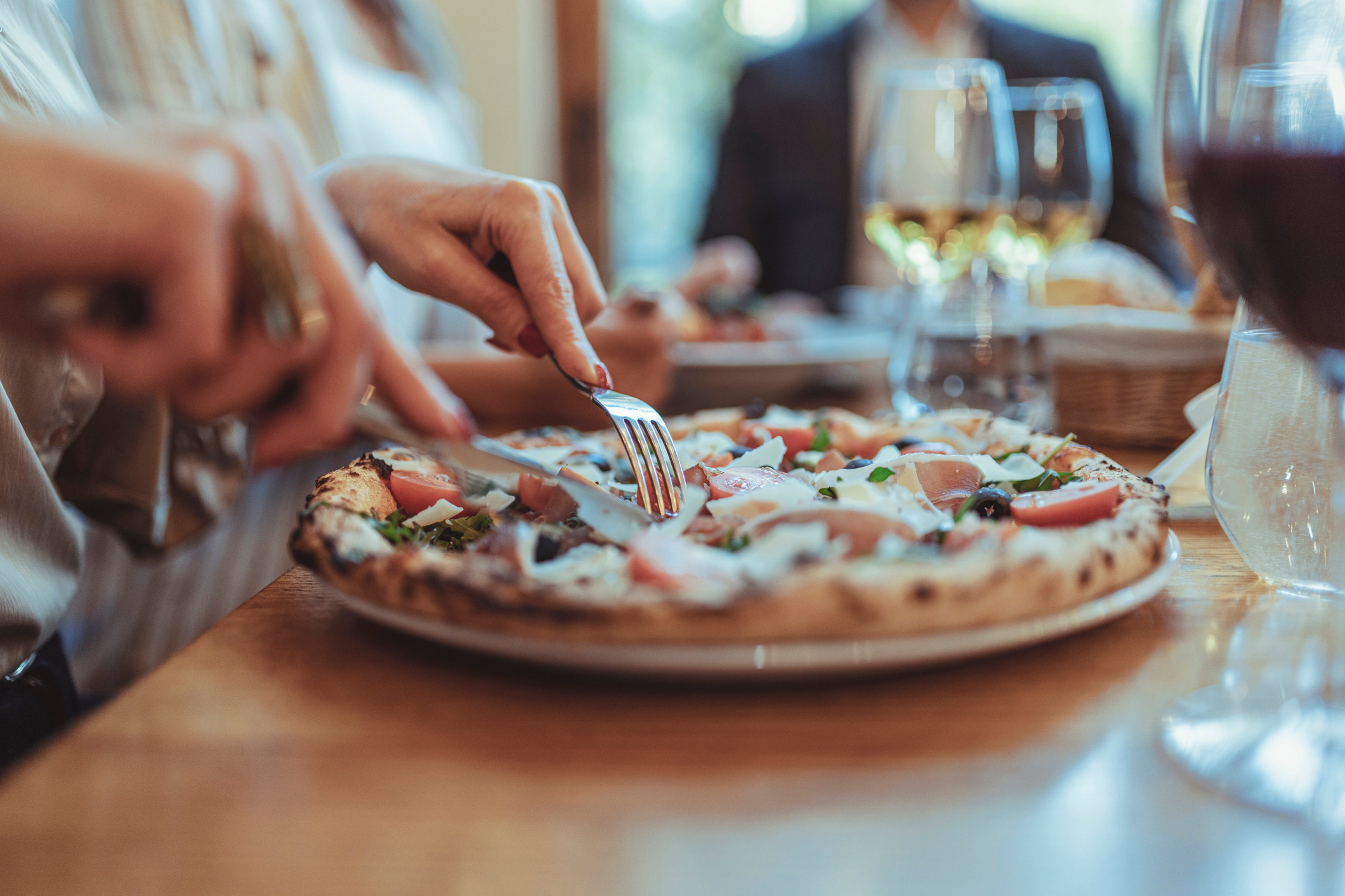 Person eating pizza at a restaurant