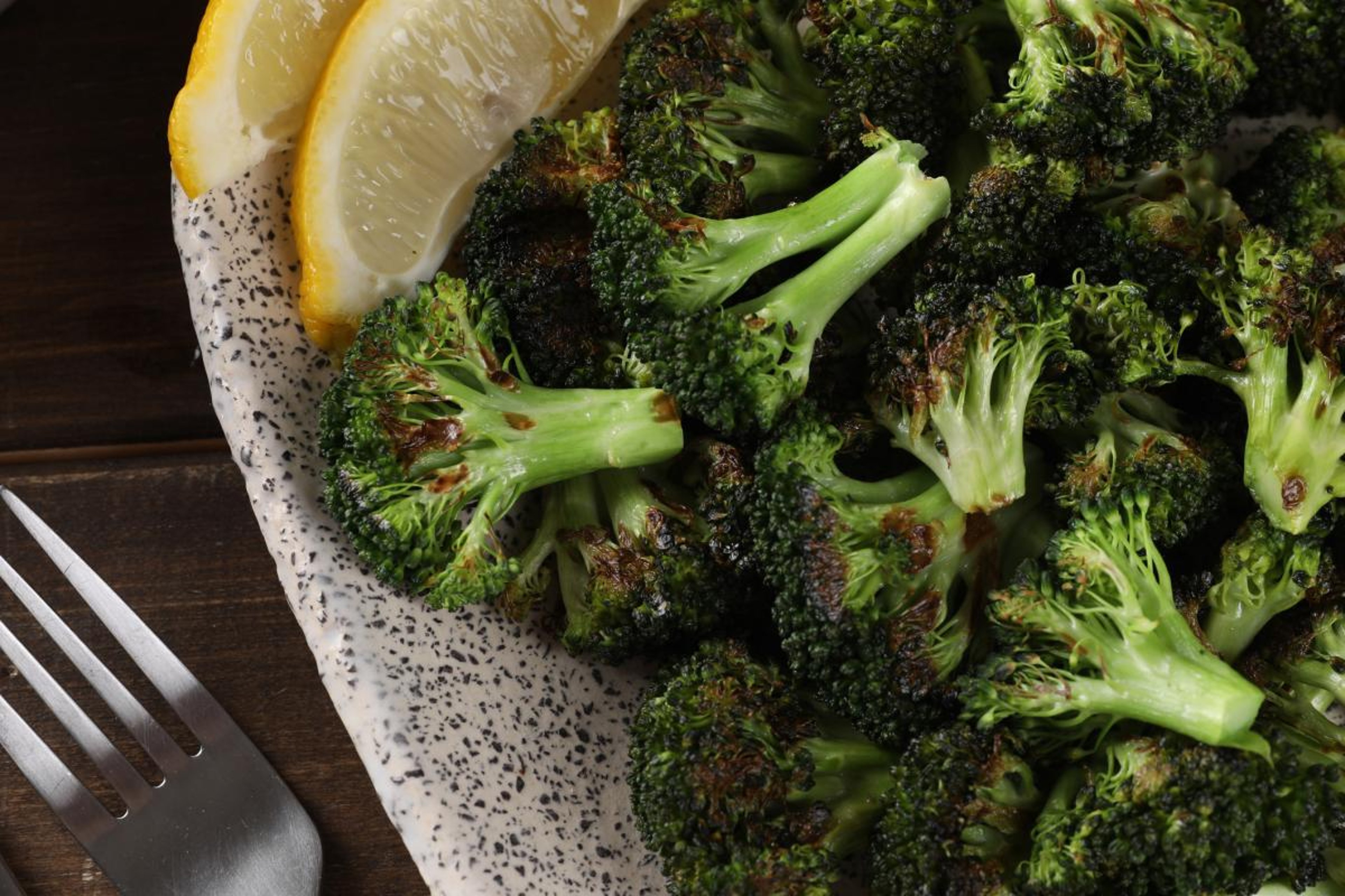 Roasted Broccoli with Lemon Wedge in Bowl