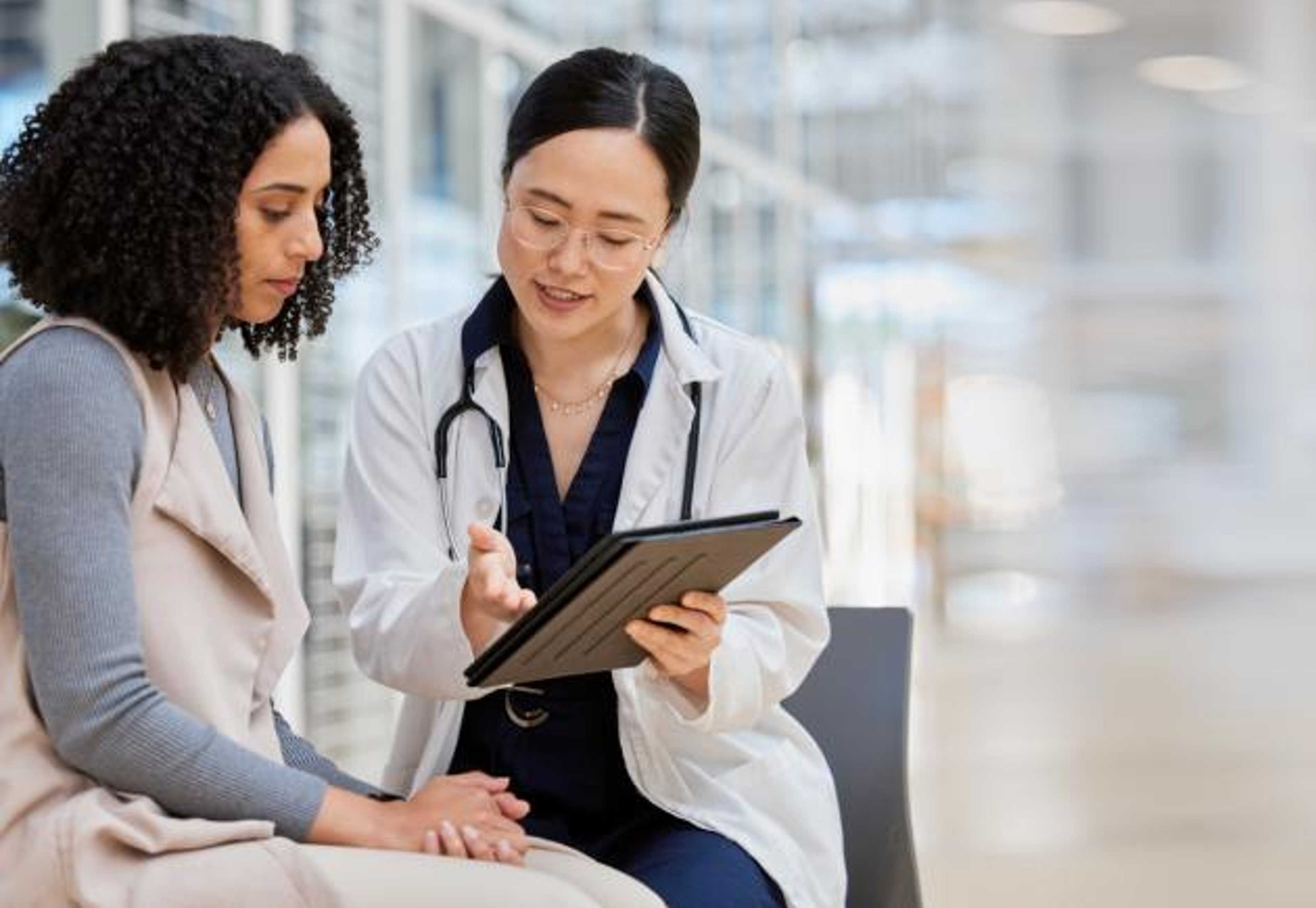 A doctor consults with a person in a lab.