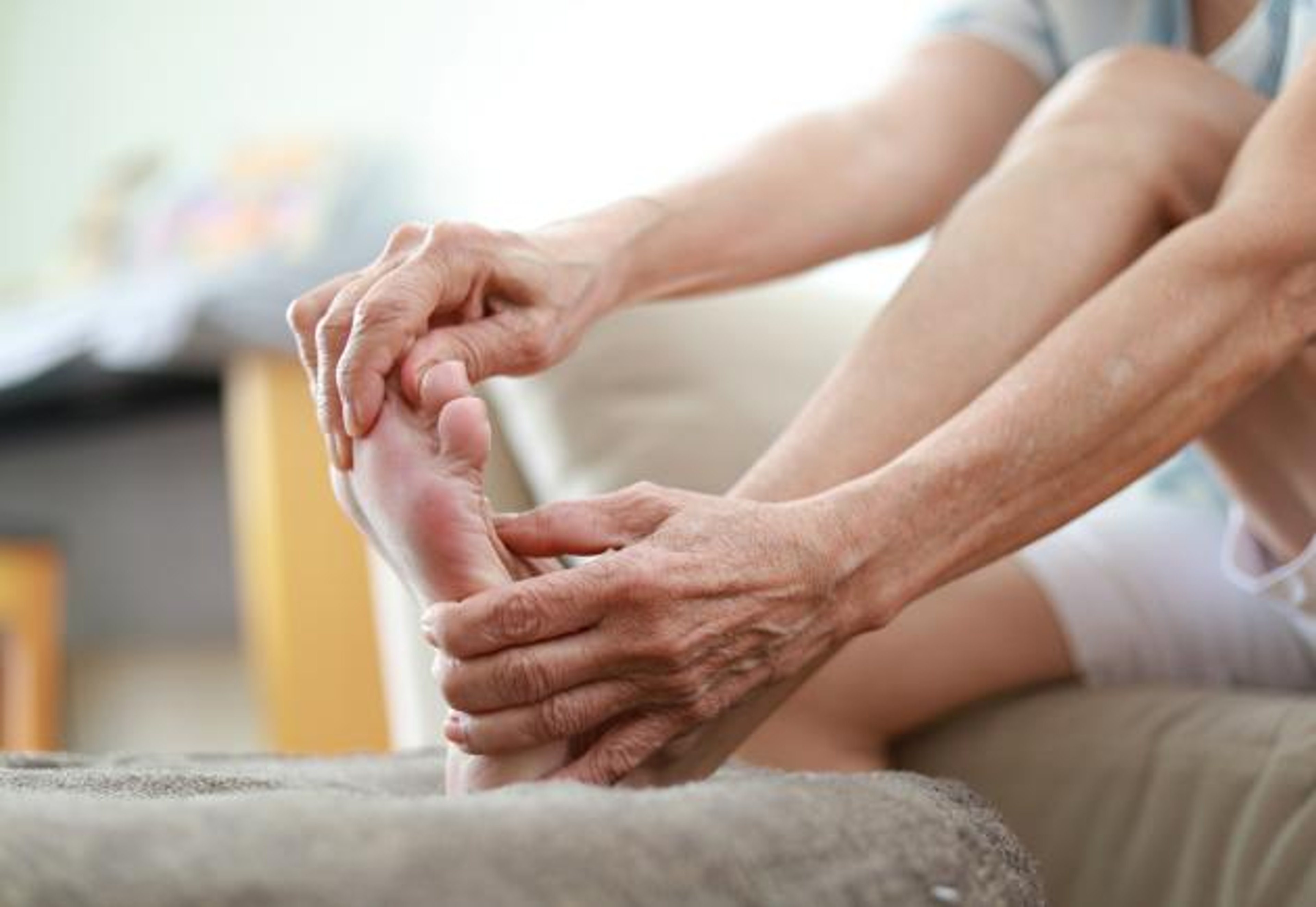 A woman massages her foot