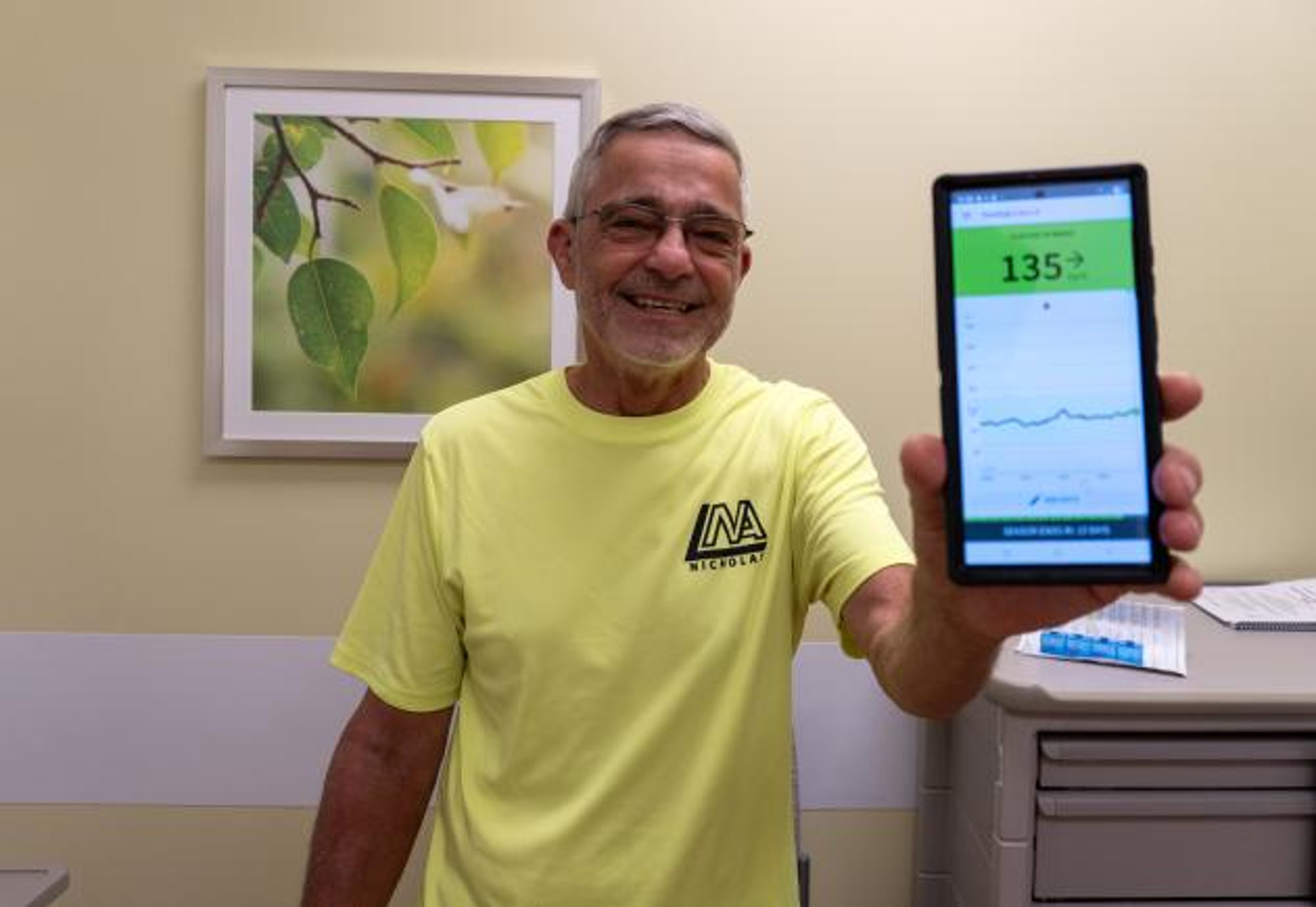 Ed Augustin, the first recipient of an FDA-approved islet cell treatment called Lantidra, showing his blood sugar reading shortly after the procedure.