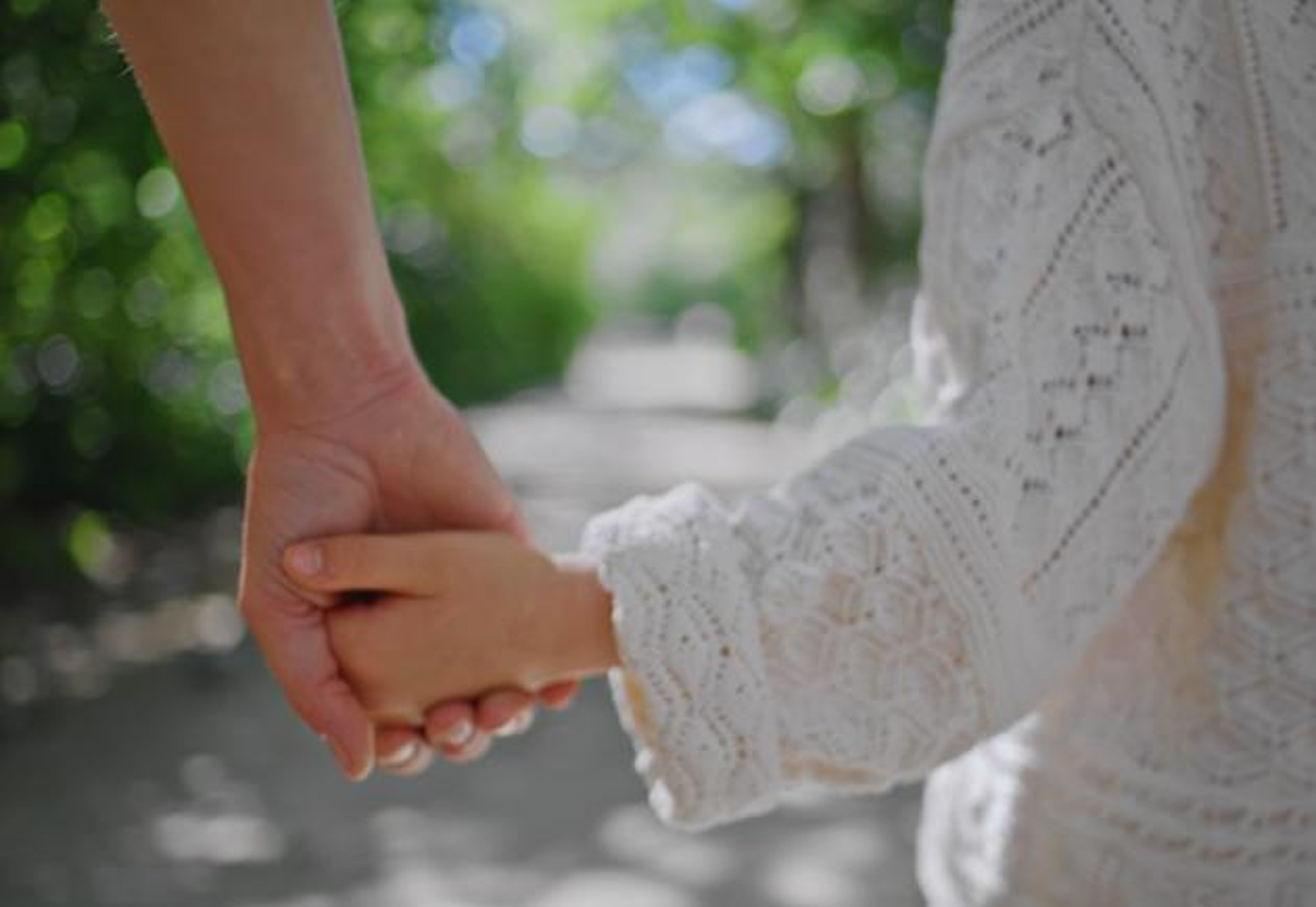 Mom holding hands with child