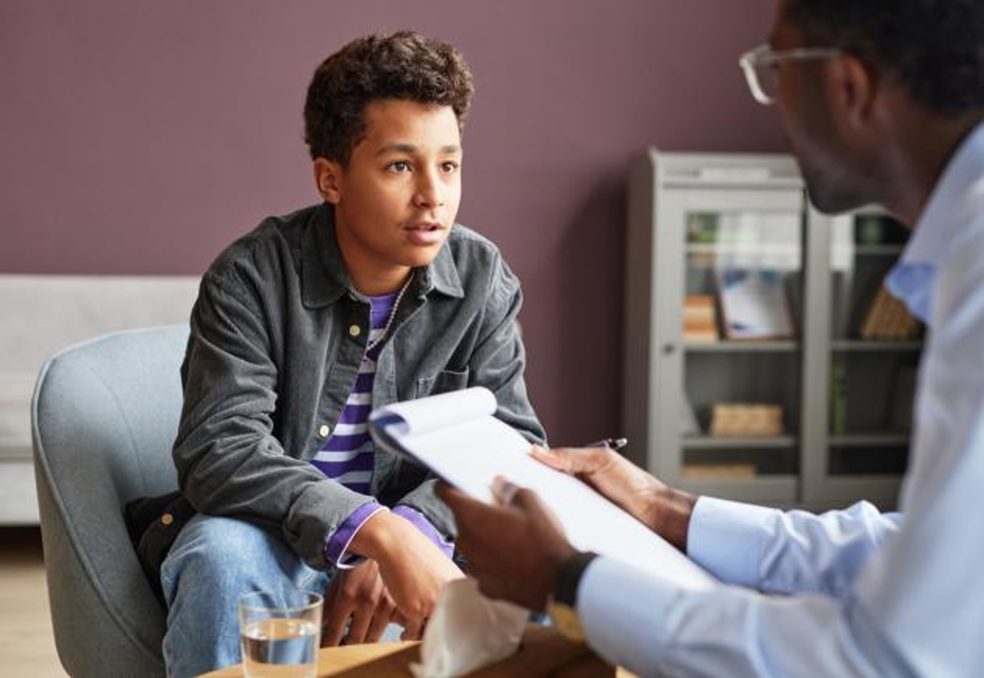Young man talking to doctor