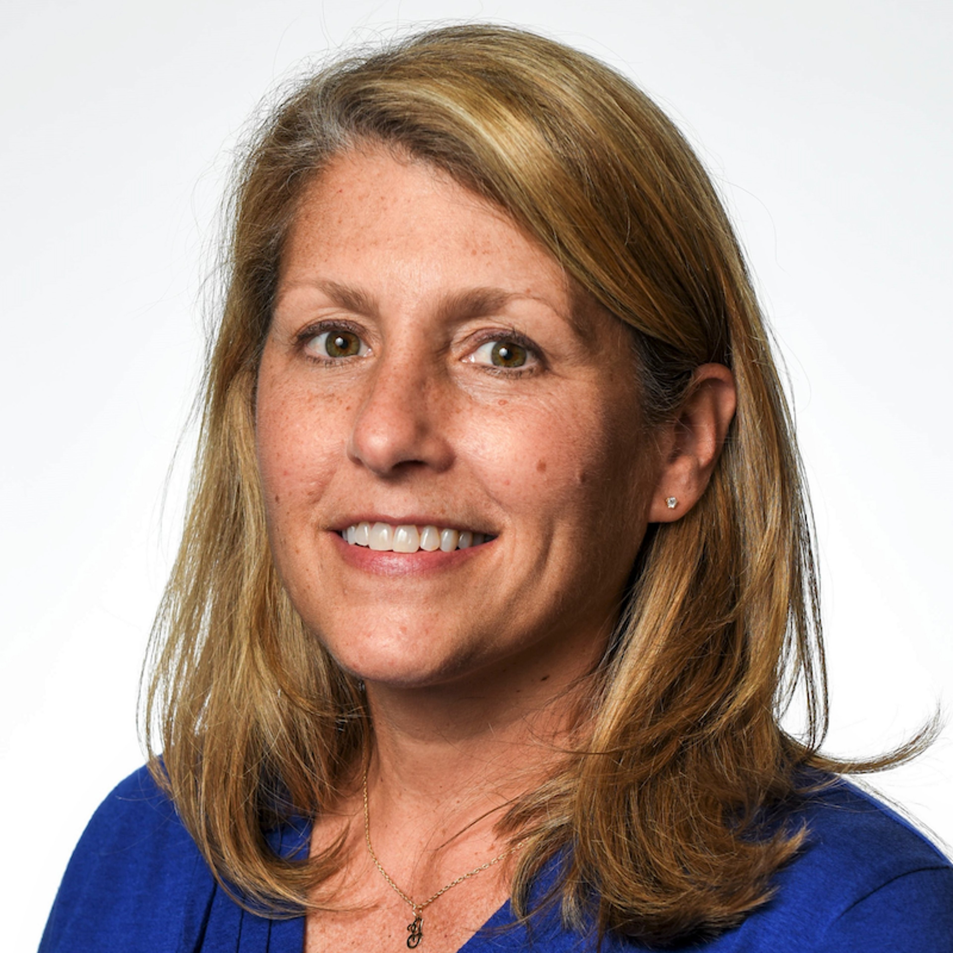 Woman with shoulder-length gold/brown hair and friendly smile
