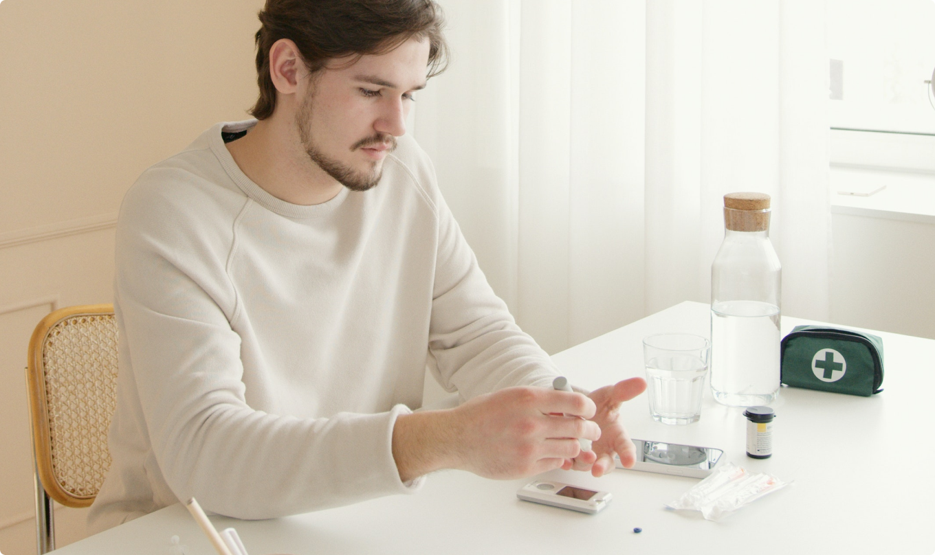 A man sitting behind a desk and taking a diabetes test