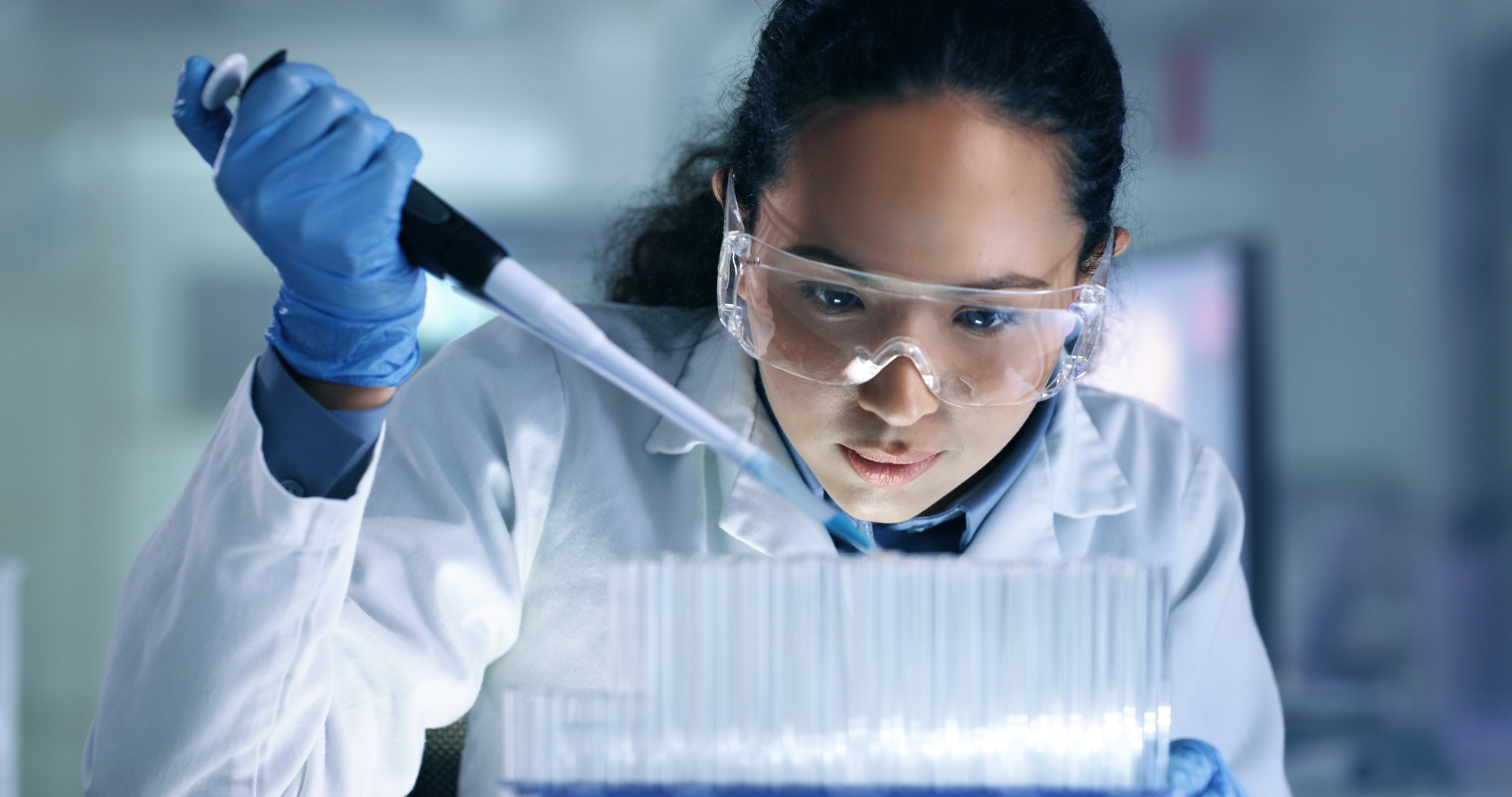Woman filling pipettes in a laboratory