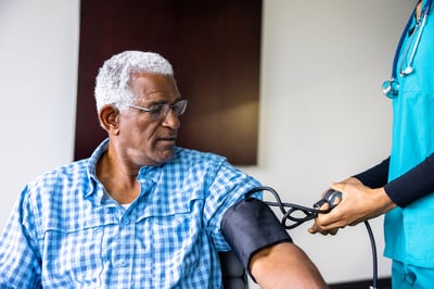 A person with diabetes receives blood pressure screening