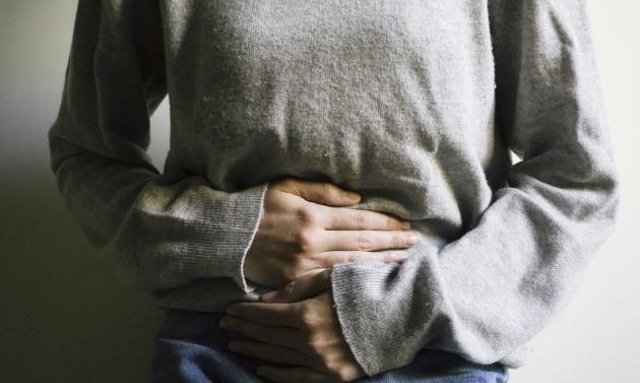 A person experiences stomach pain due to exocrine pancreatic insufficiency (EPI)