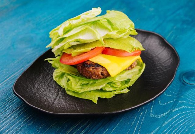 Lettuce-wrapped smash and fry burger on a plate
