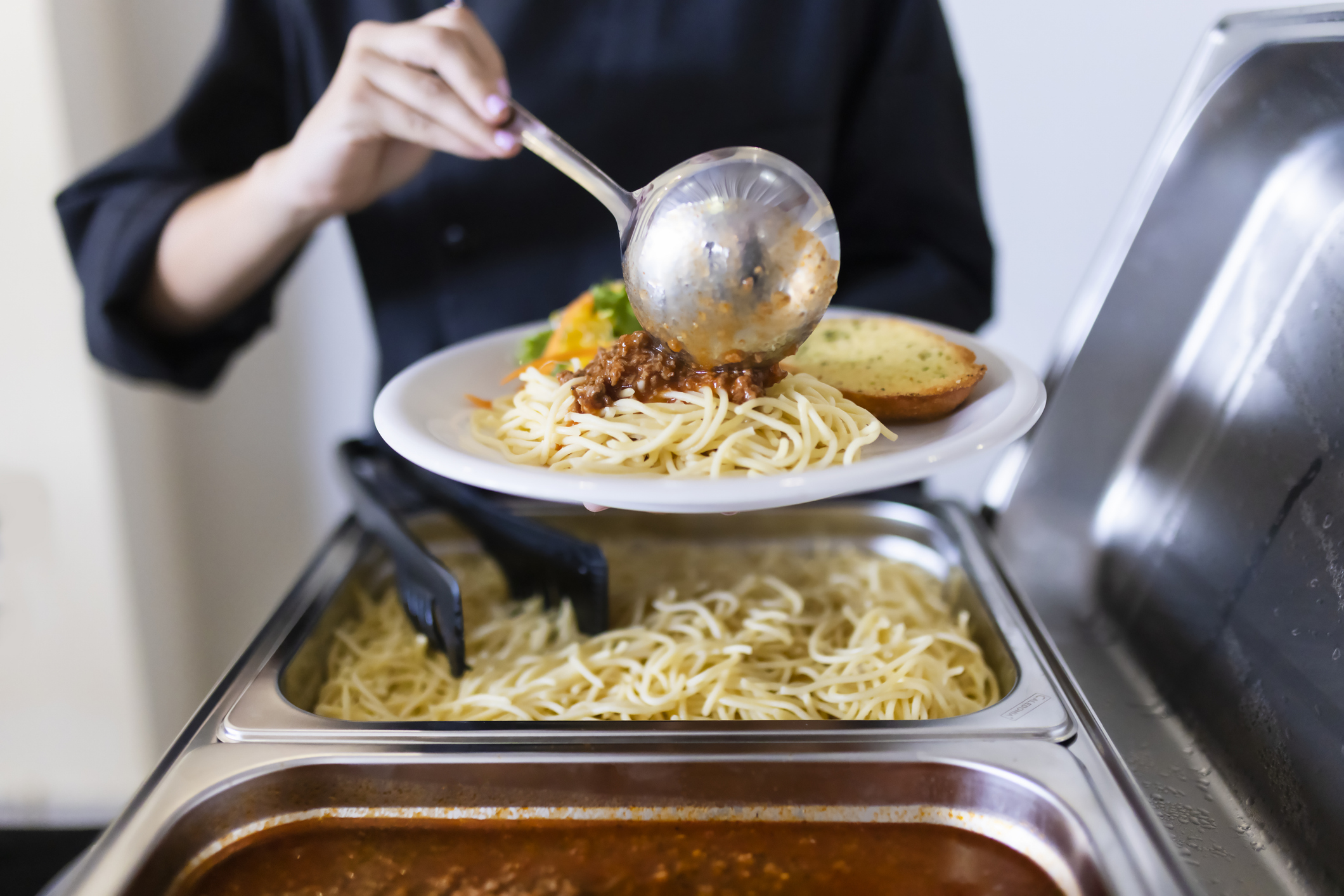 Cook serving food on a plate stock photo