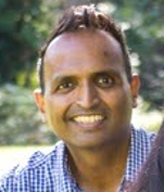 Darker-skinned man of South Asian heritage with friendly eyes and smile
