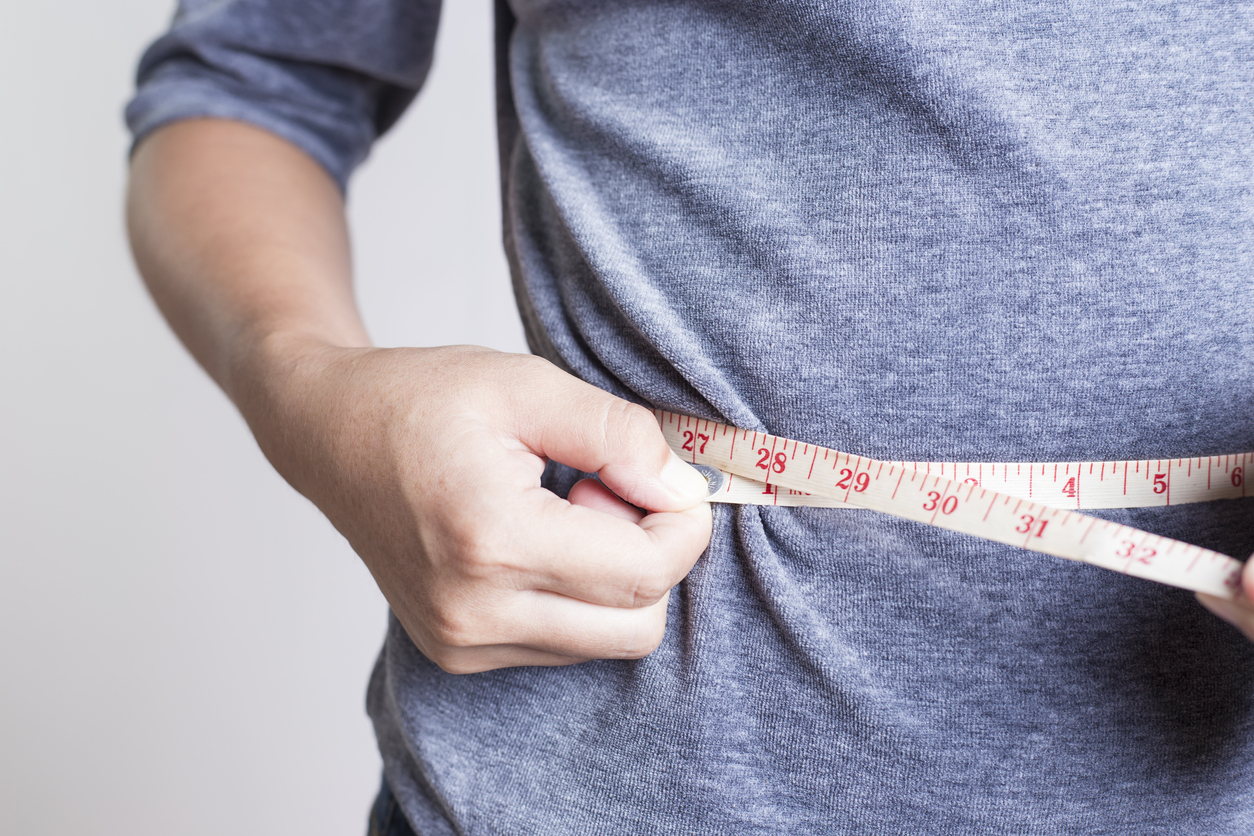 Man measuring waistline