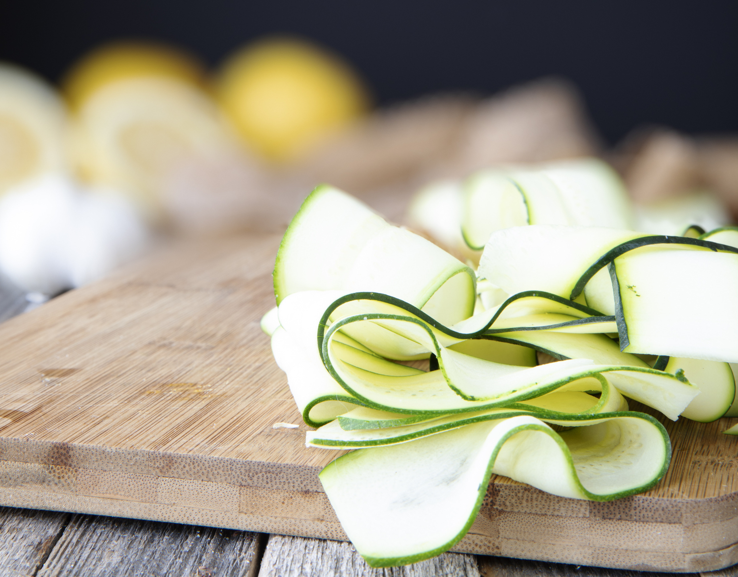 Shaved zucchini ribbons on cutting board