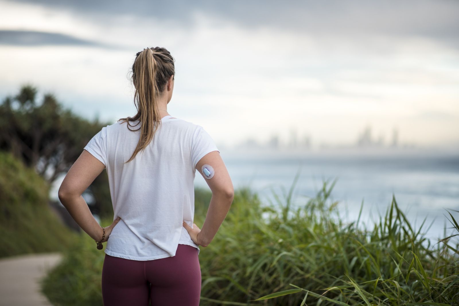 A woman wearing a CGM