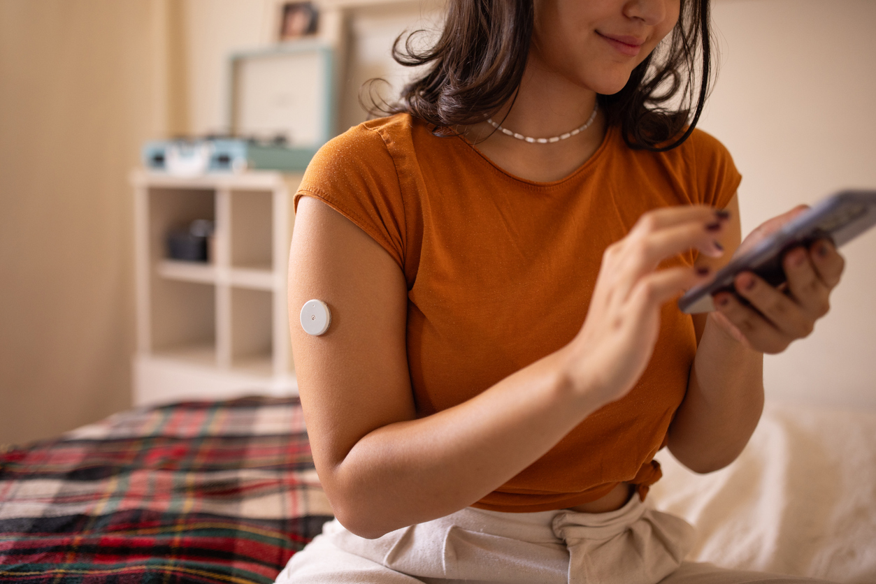 A woman wears a CGM