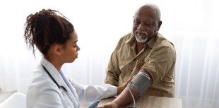 A person with diabetes receives a blood pressure screening