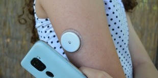 child wearing continuous glucose monitor